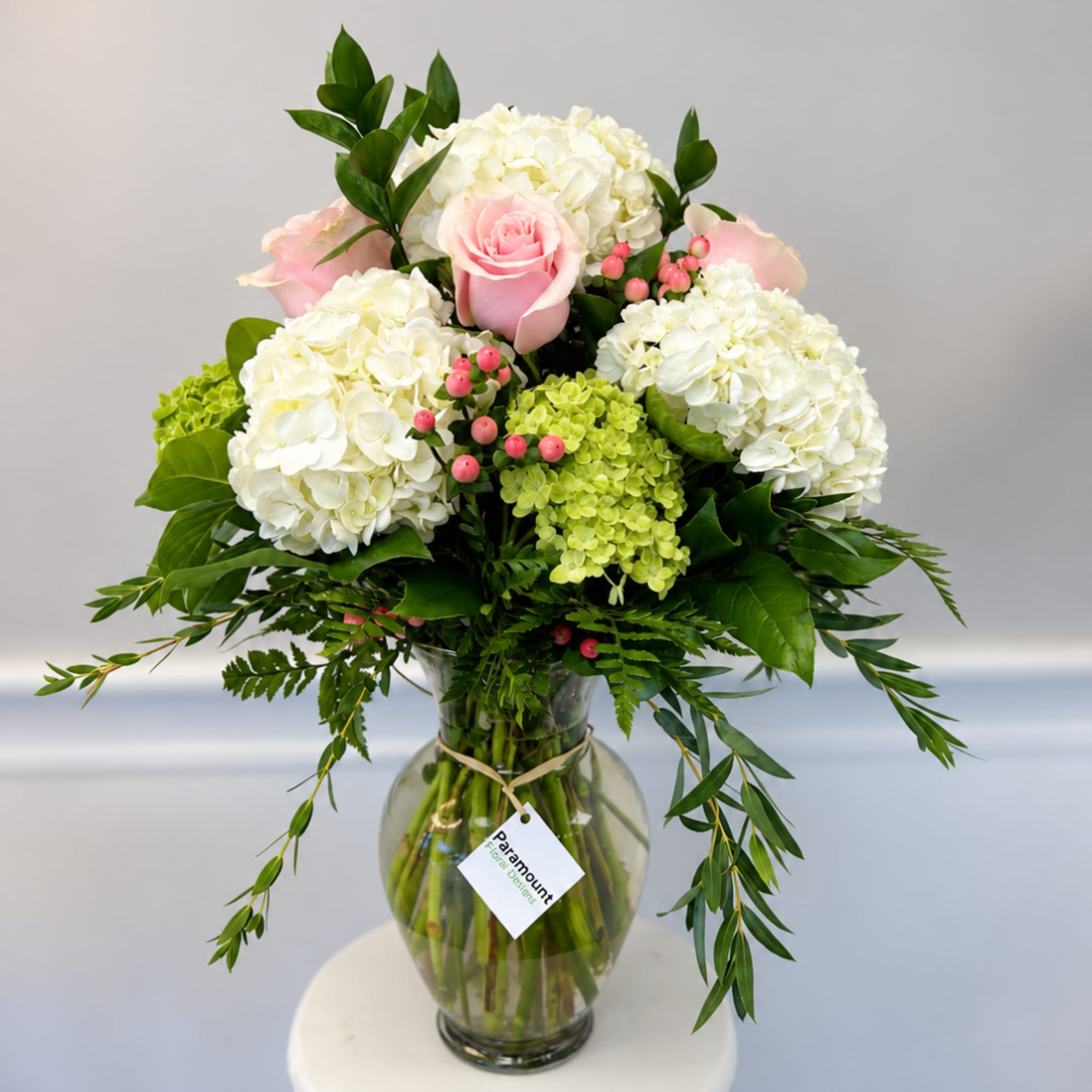 Pink roses and white hydrangeas in a glass vase