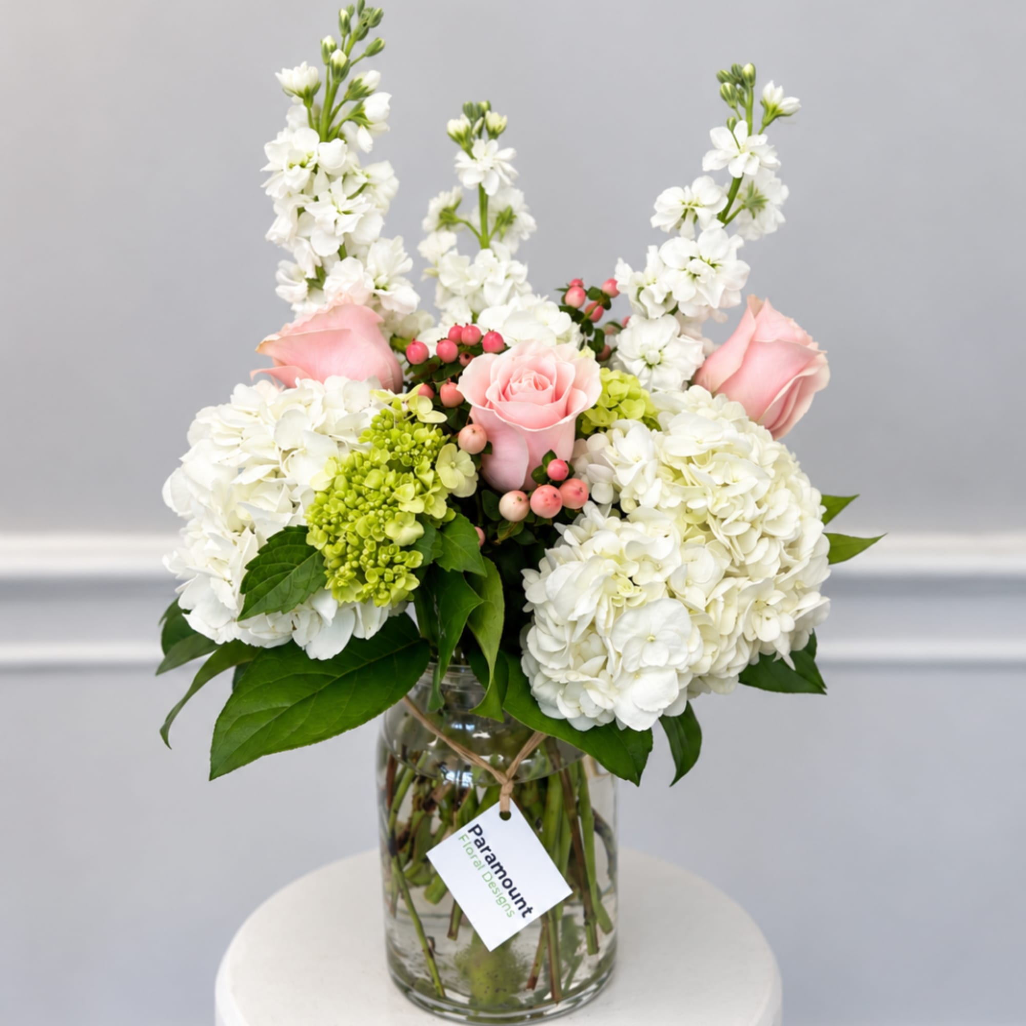 Pink roses and white hydrangeas in a glass vase