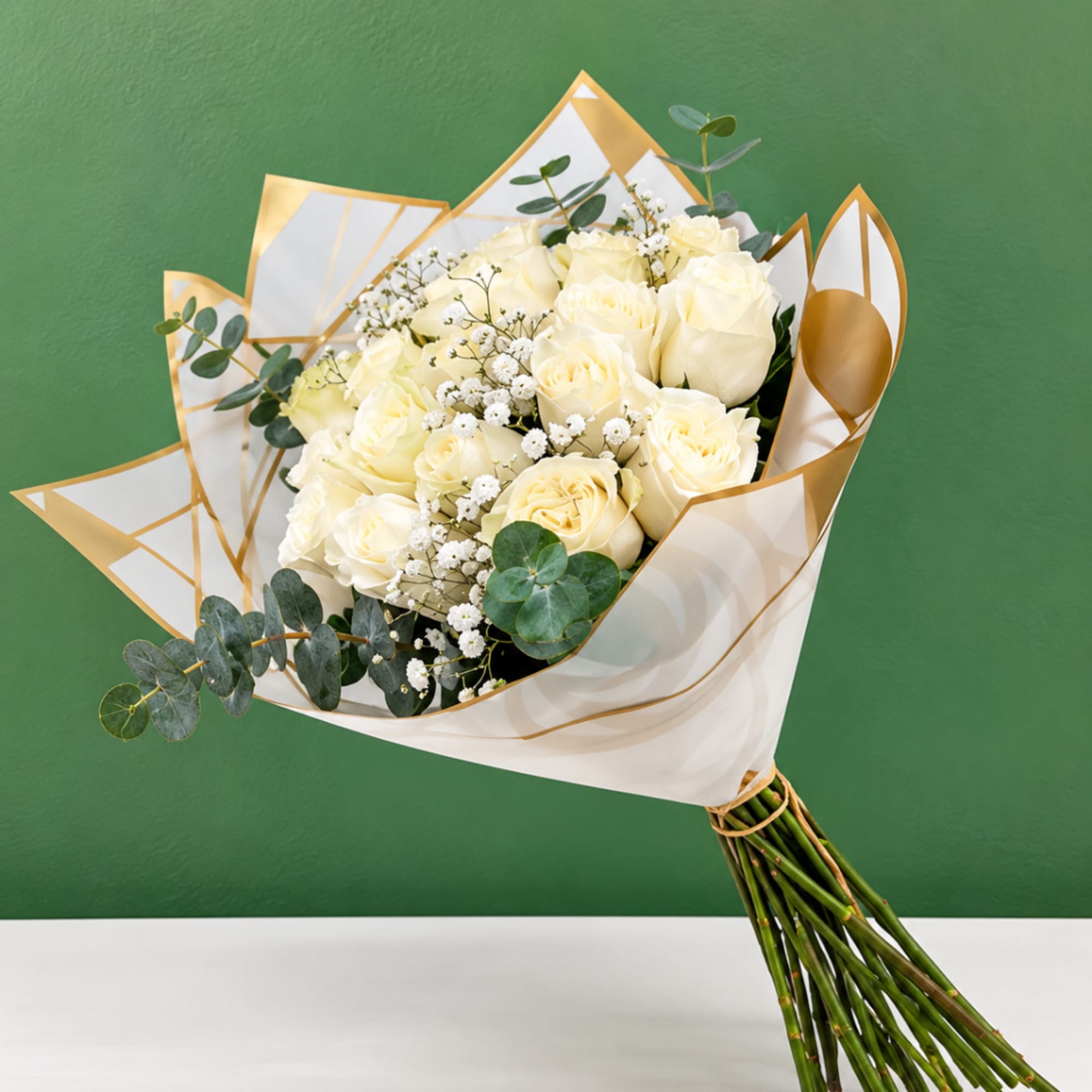 Bouquet of cream roses with baby's breath and eucalyptus in white-and-gold wrap