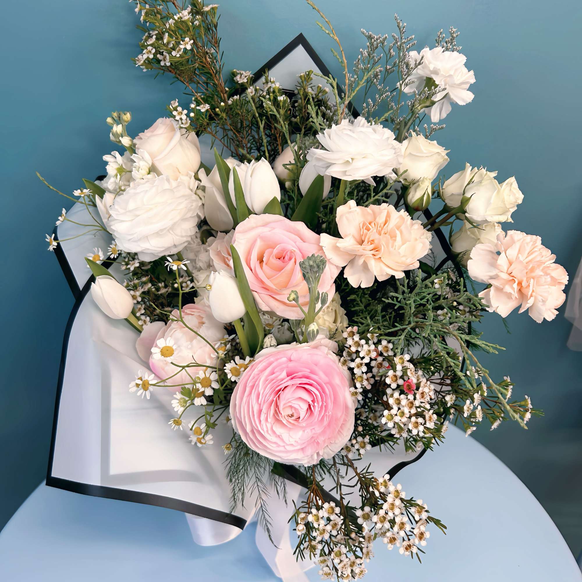Pink and white mixed bouquet with roses, ranunculus, tulips, and carnations