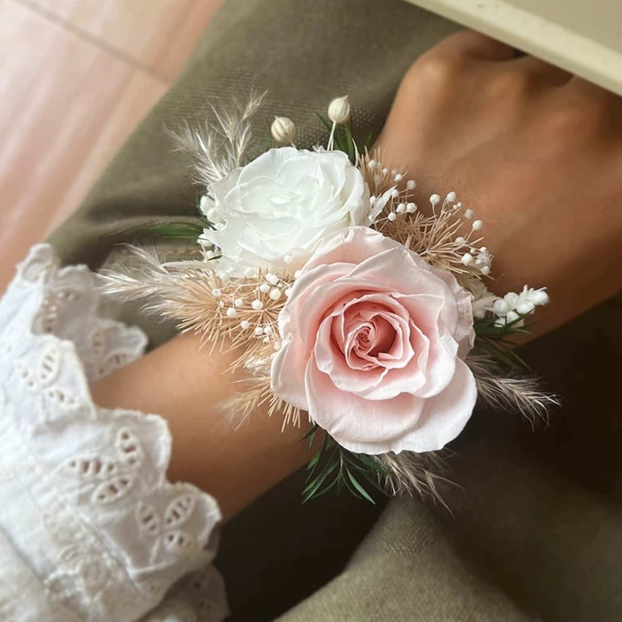 Pink and white rose wrist corsage with delicate filler flowers
