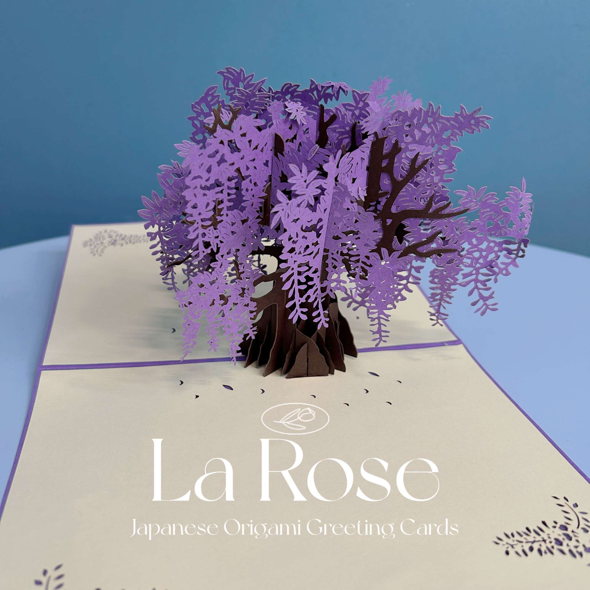 Pop-up paper tree card with purple blossoms on a greeting card