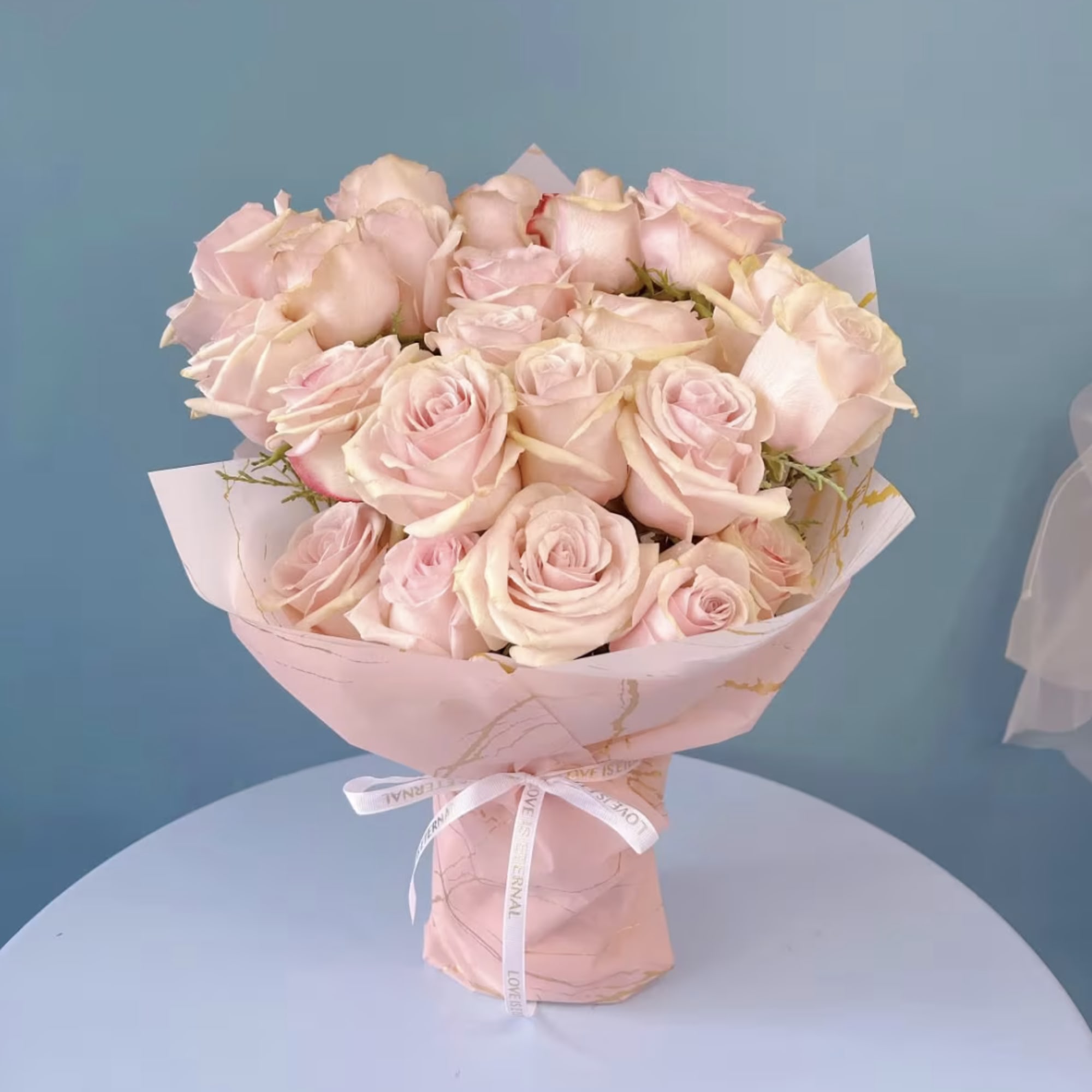 Indulge in the elegance of premium roses, beautifully arranged with complementary floral
