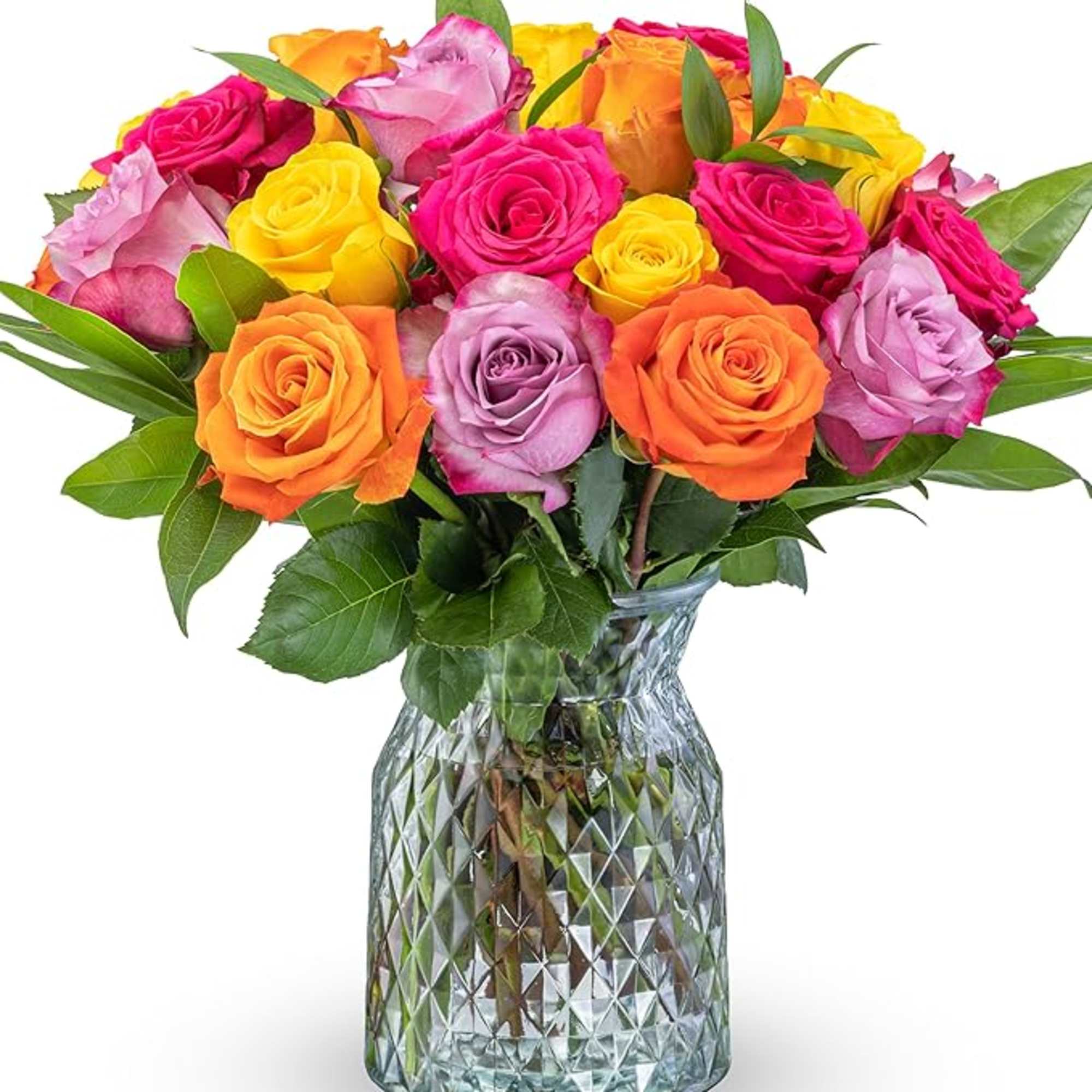 Mixed roses in bright pink, yellow, orange, and lavender in a glass vase