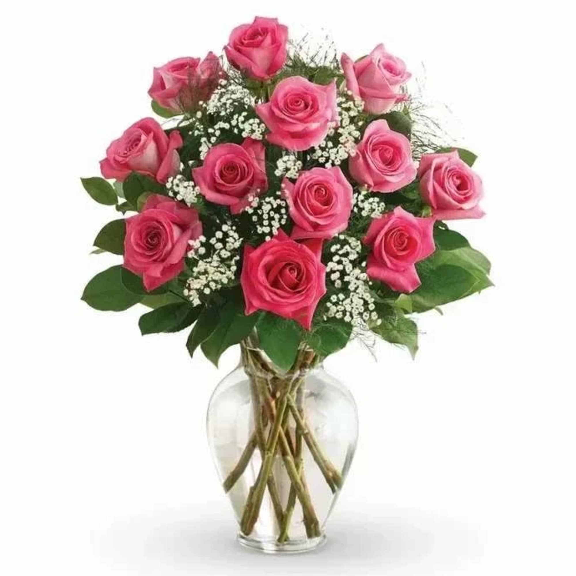 Pink roses arranged in a clear glass vase with baby's breath