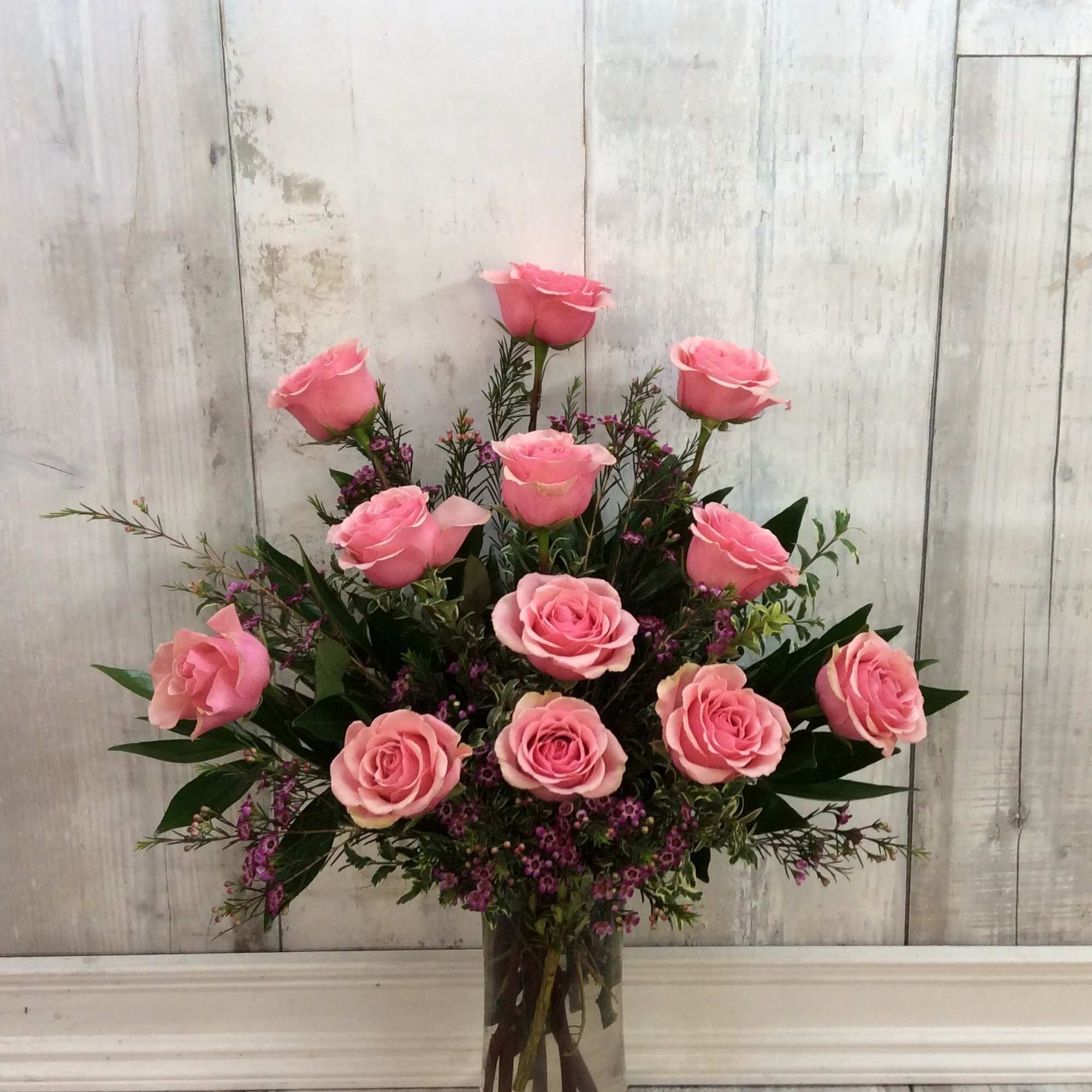 12 beautiful light pink roses arranged in a glass vase. 

*Light pink, photo 2 of 2