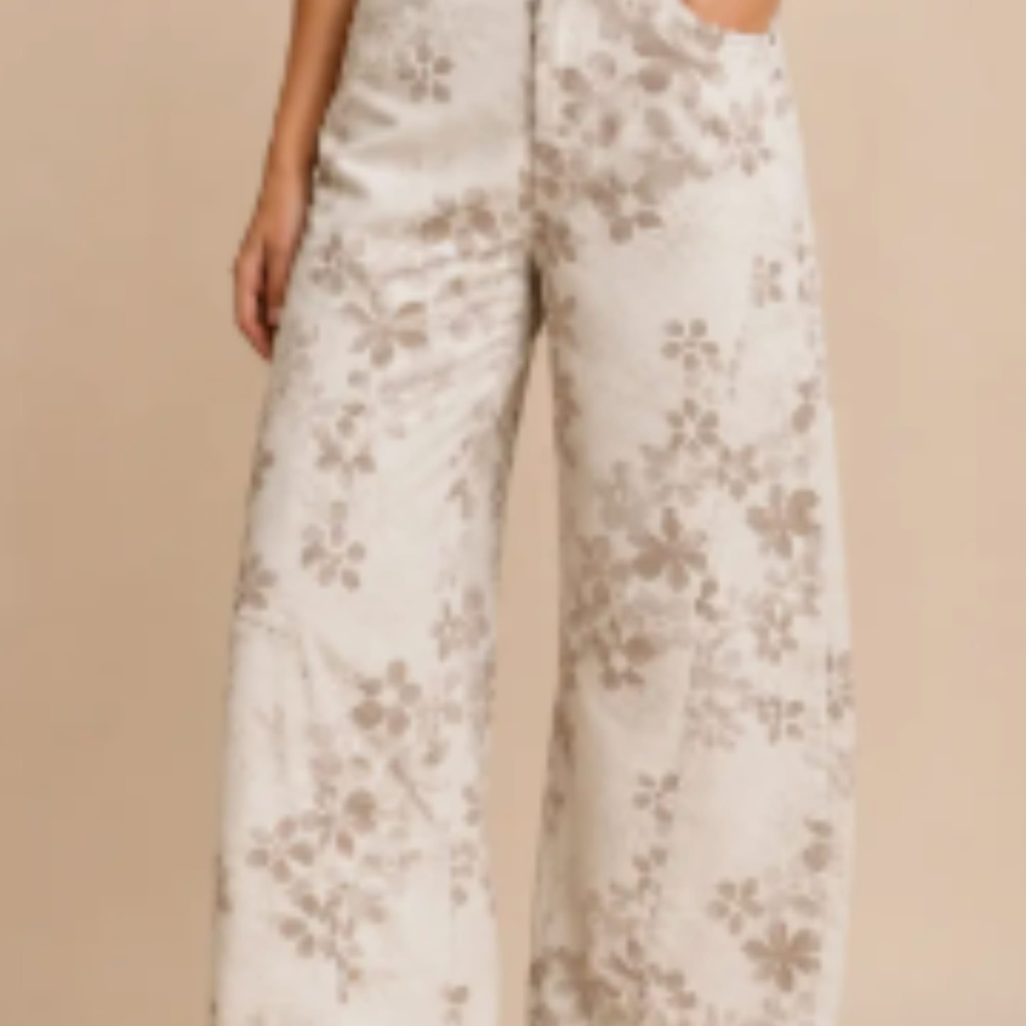 Person wearing cream floral-patterned wide-leg pants