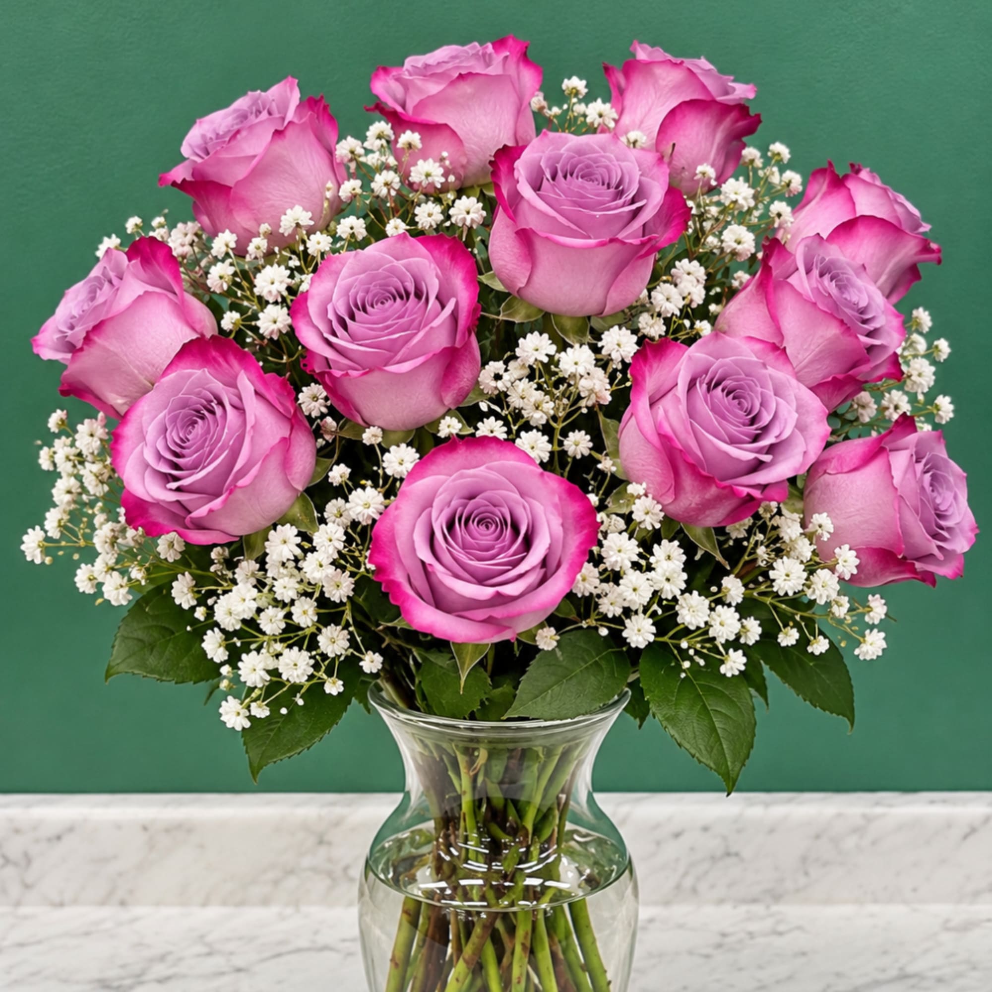 Pink roses and white baby's breath in a clear glass vase
