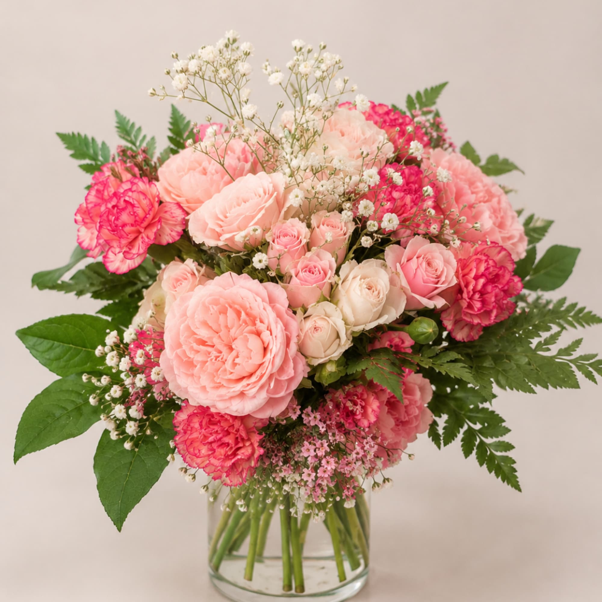 Pink and peach bouquet in a clear glass vase
