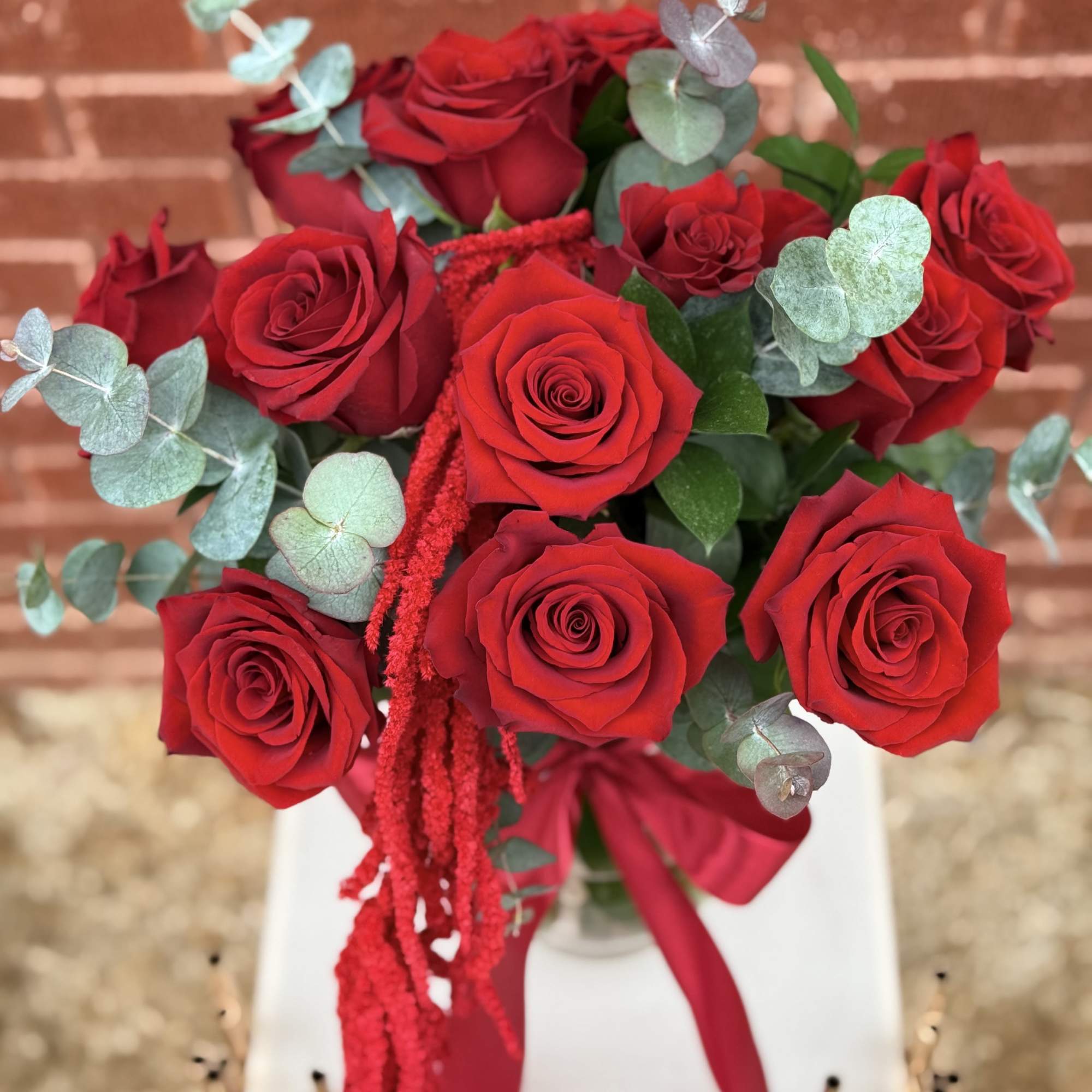 Bouquet of red roses with eucalyptus and a red ribbon