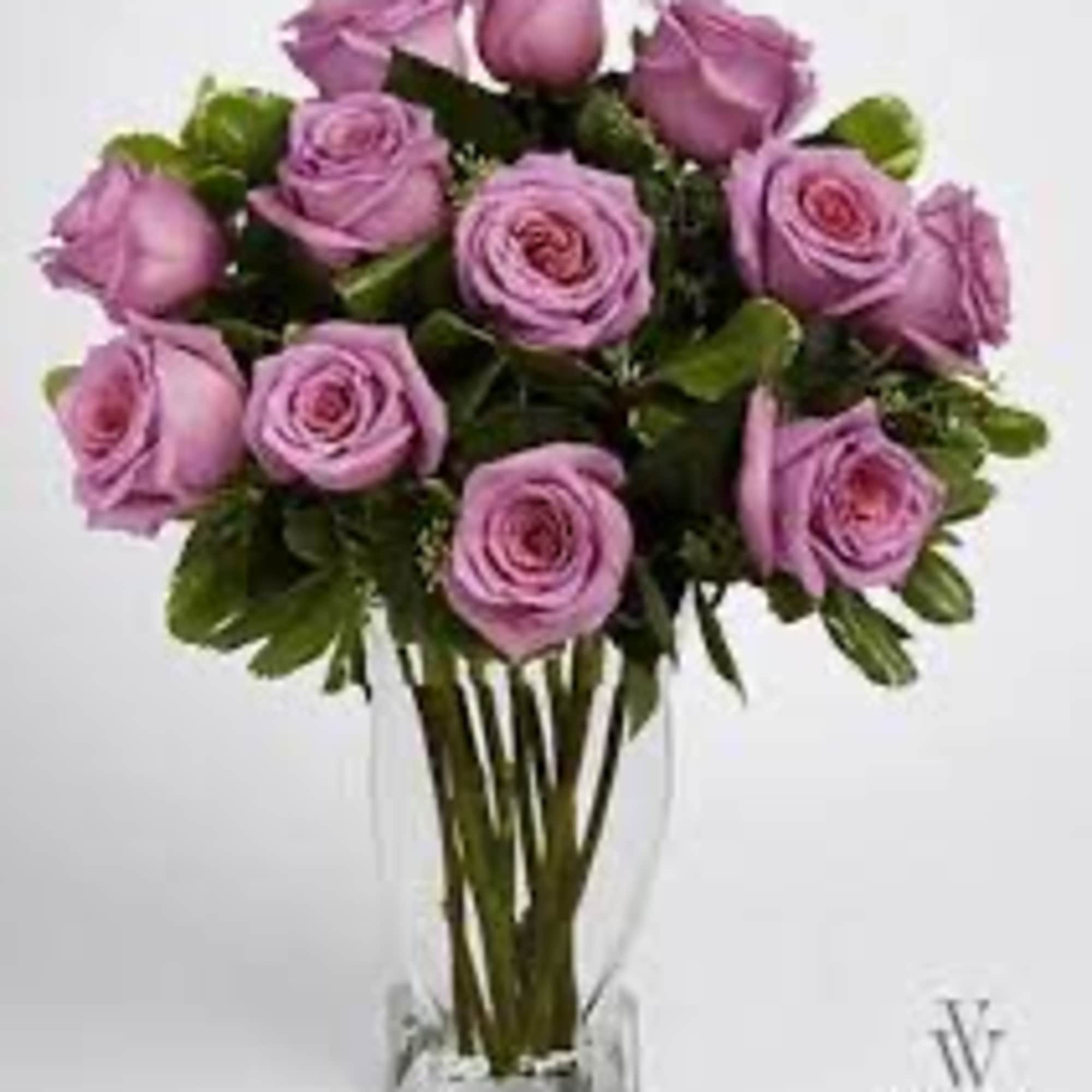 Lavender rose bouquet in a clear glass vase