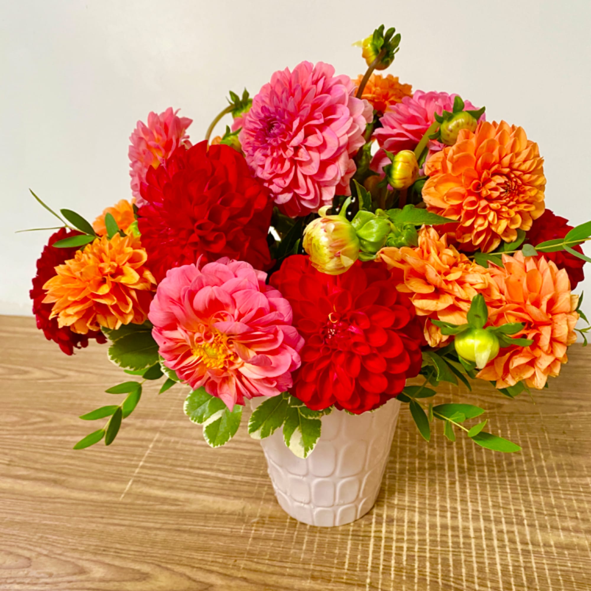 Bright mixed dahlia bouquet in a white vase, photo 2 of 6