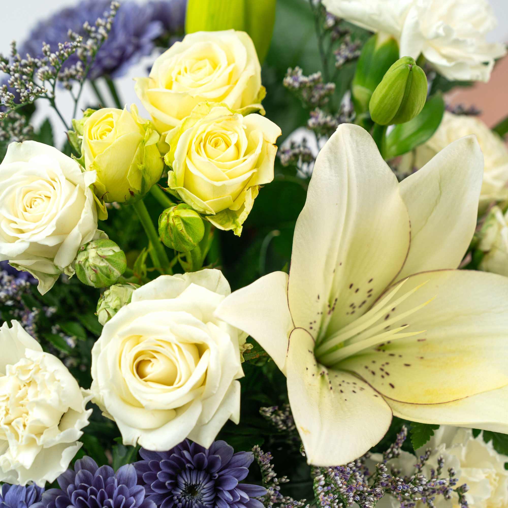 Bouquet of white roses, lilies, and purple daisies