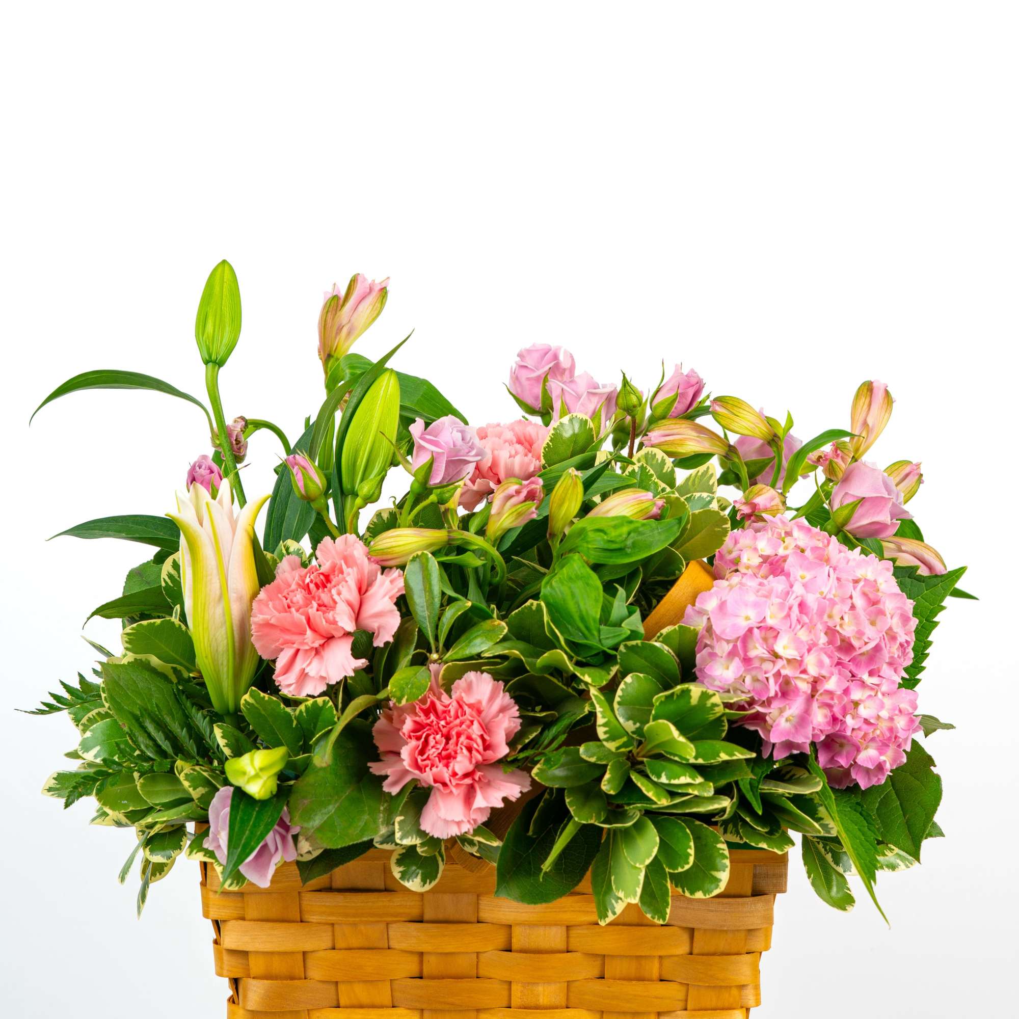 Pink flowers and lilies arranged in a woven basket