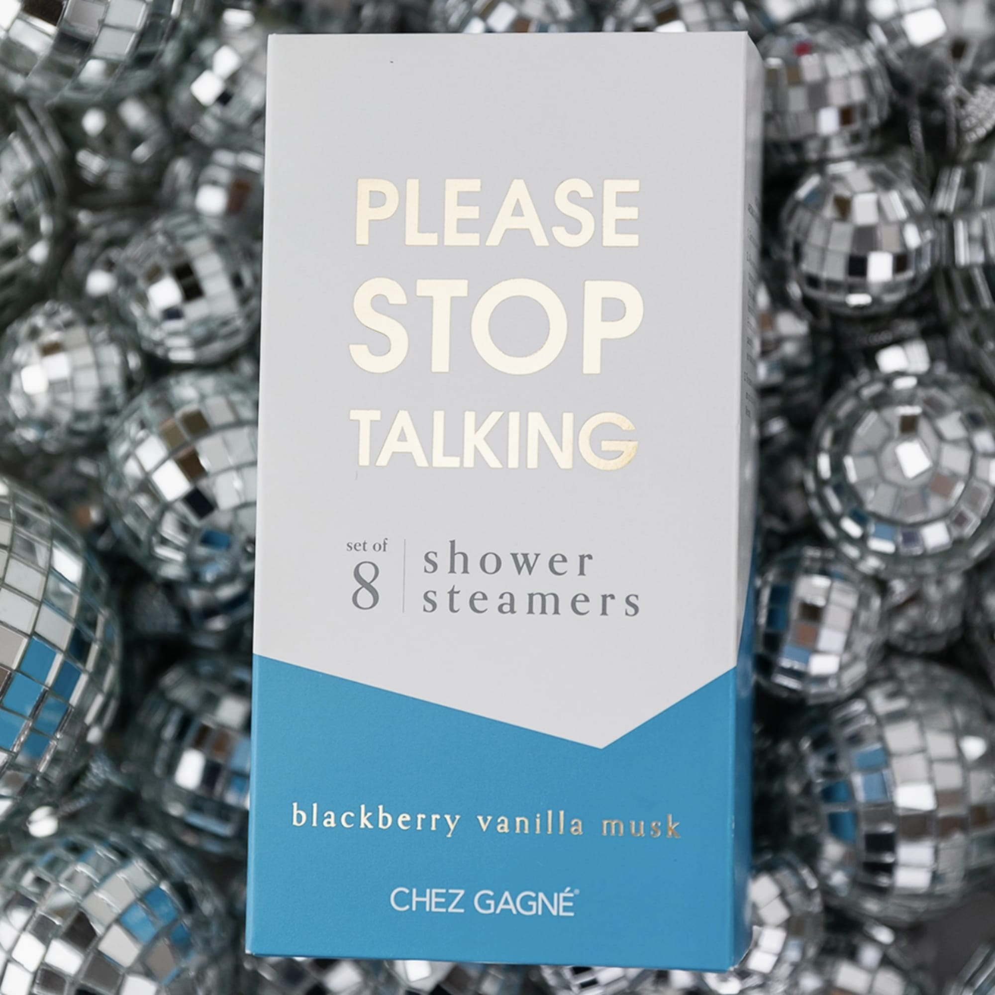 Box of shower steamers on a mirrored disco ball background