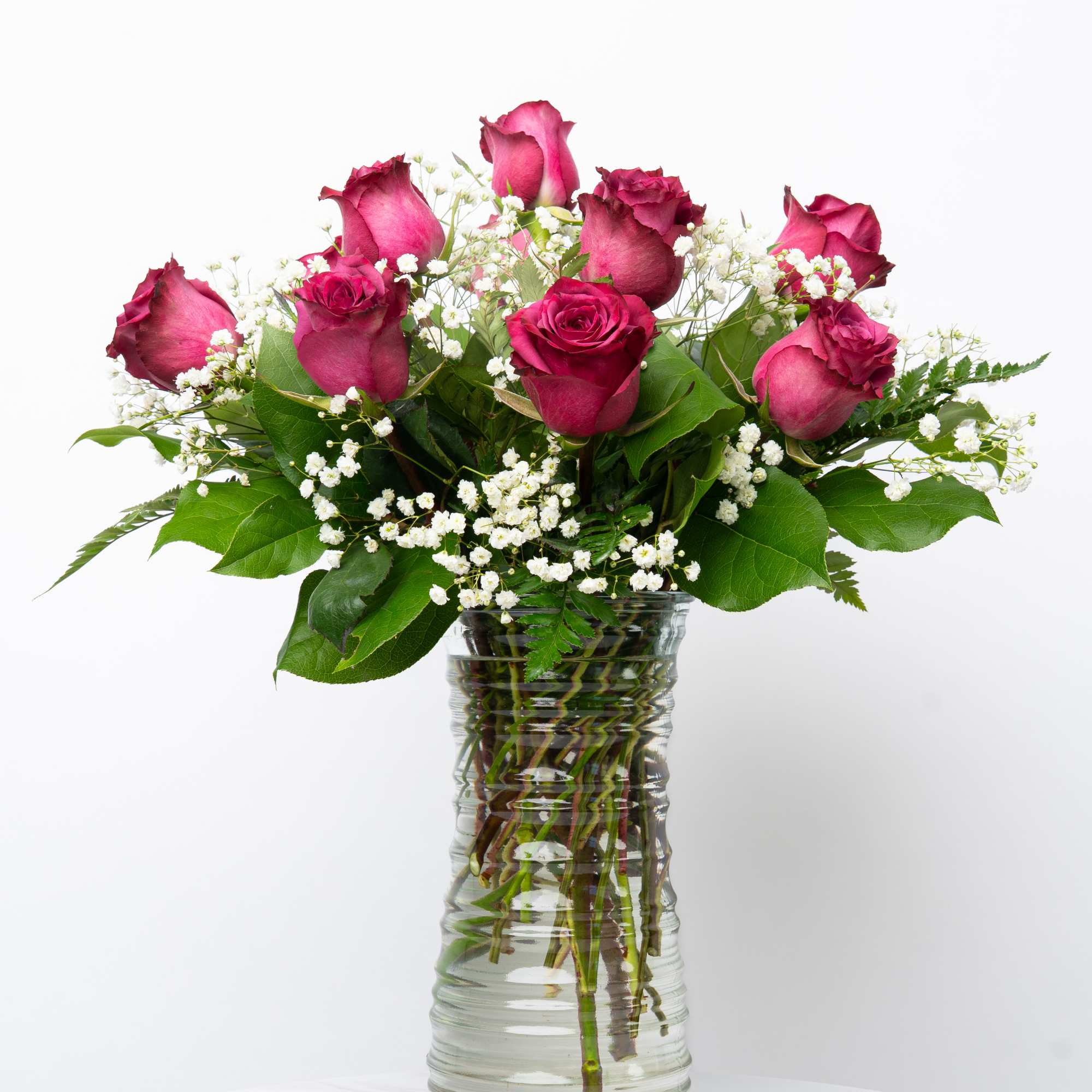 Pink roses and baby's breath in a clear glass vase