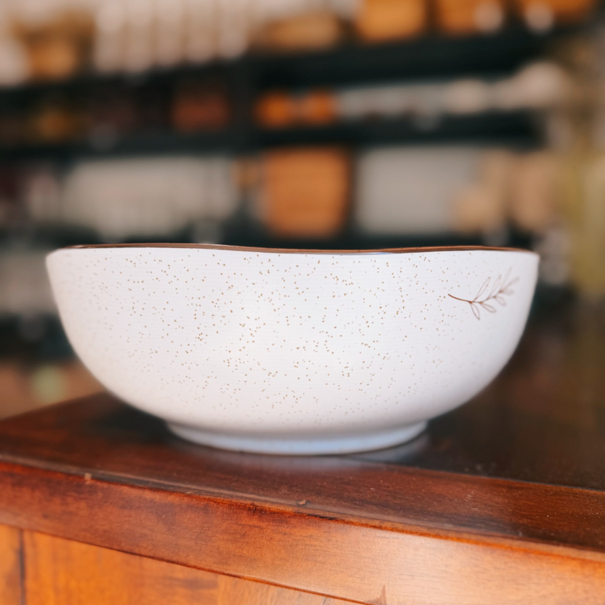 White speckled ceramic bowl on a wooden surface