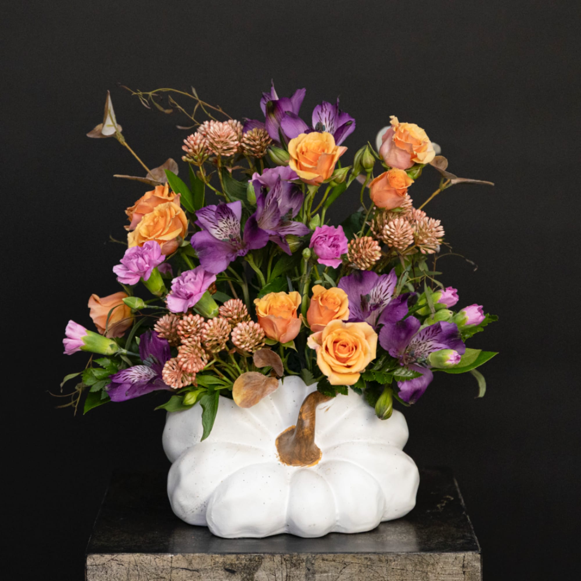 Orange and purple flower arrangement in a white pumpkin vase, photo 2 of 4