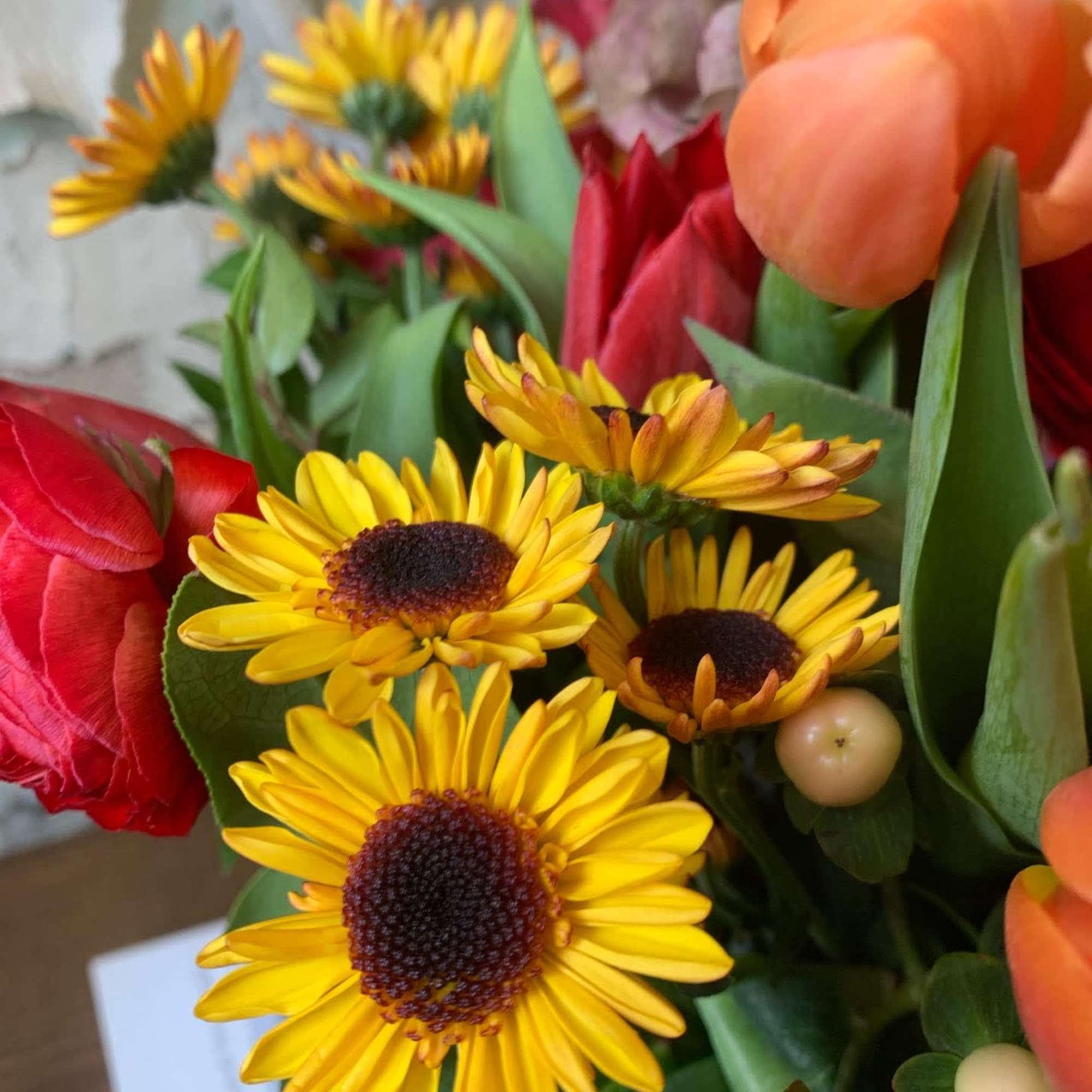 An enchanting display of sunflowers, ranunculus, mums and tulips. , photo 3 of 4