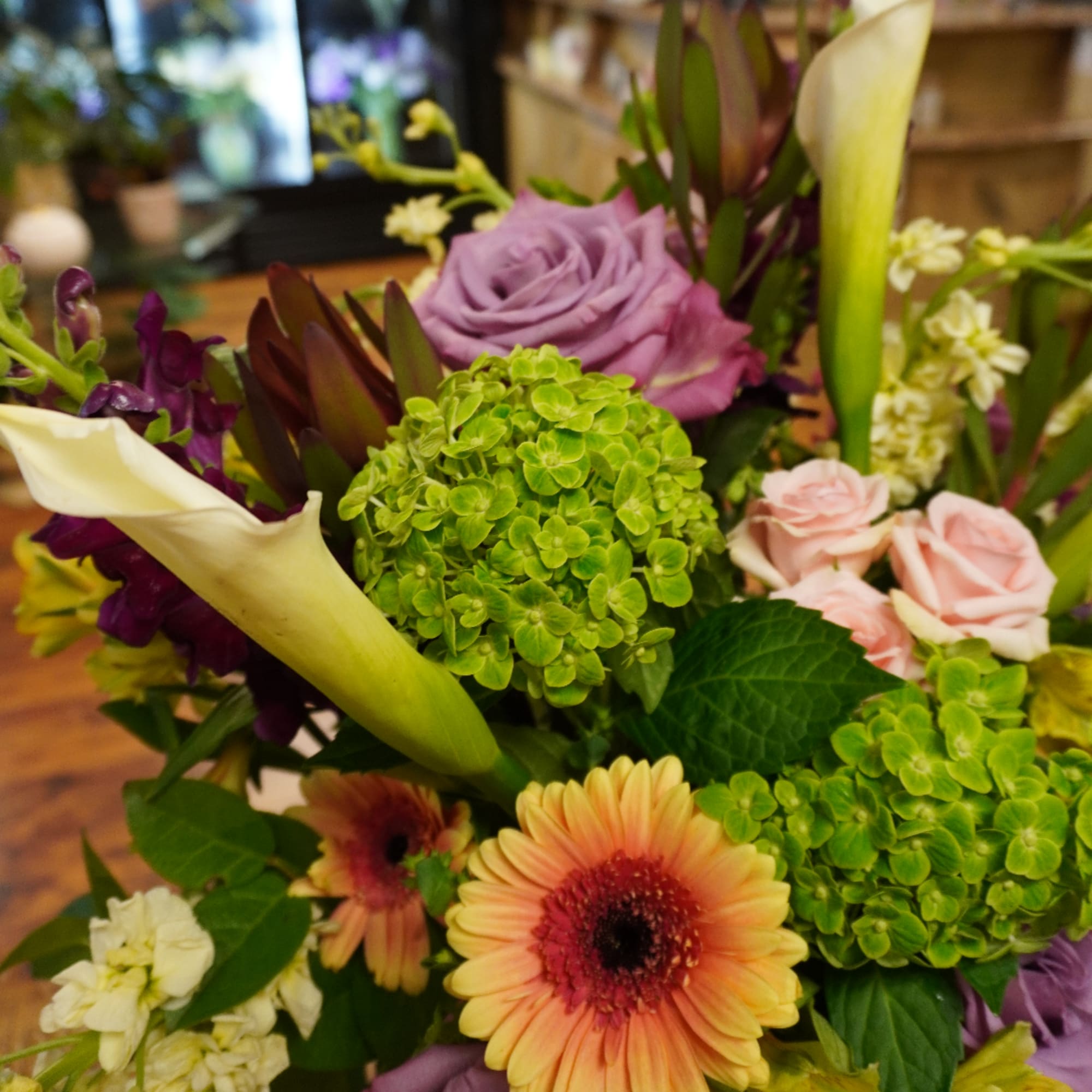 Mixed bouquet with calla lilies, roses, hydrangea, and gerbera daisies