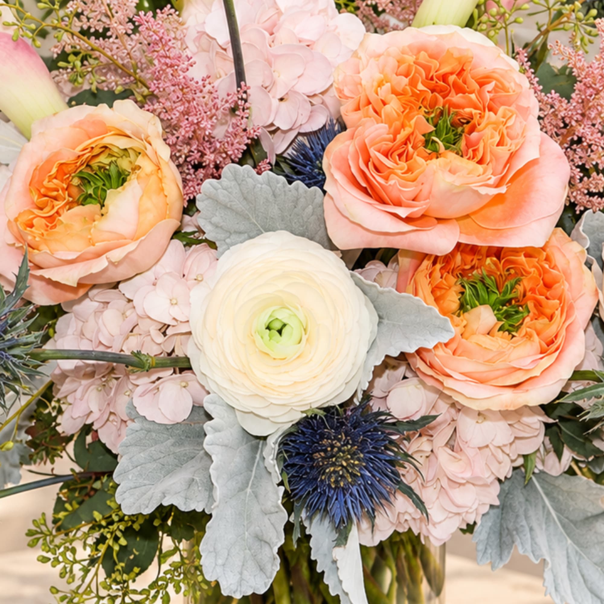 Bouquet of peach and white flowers with pale pink accents