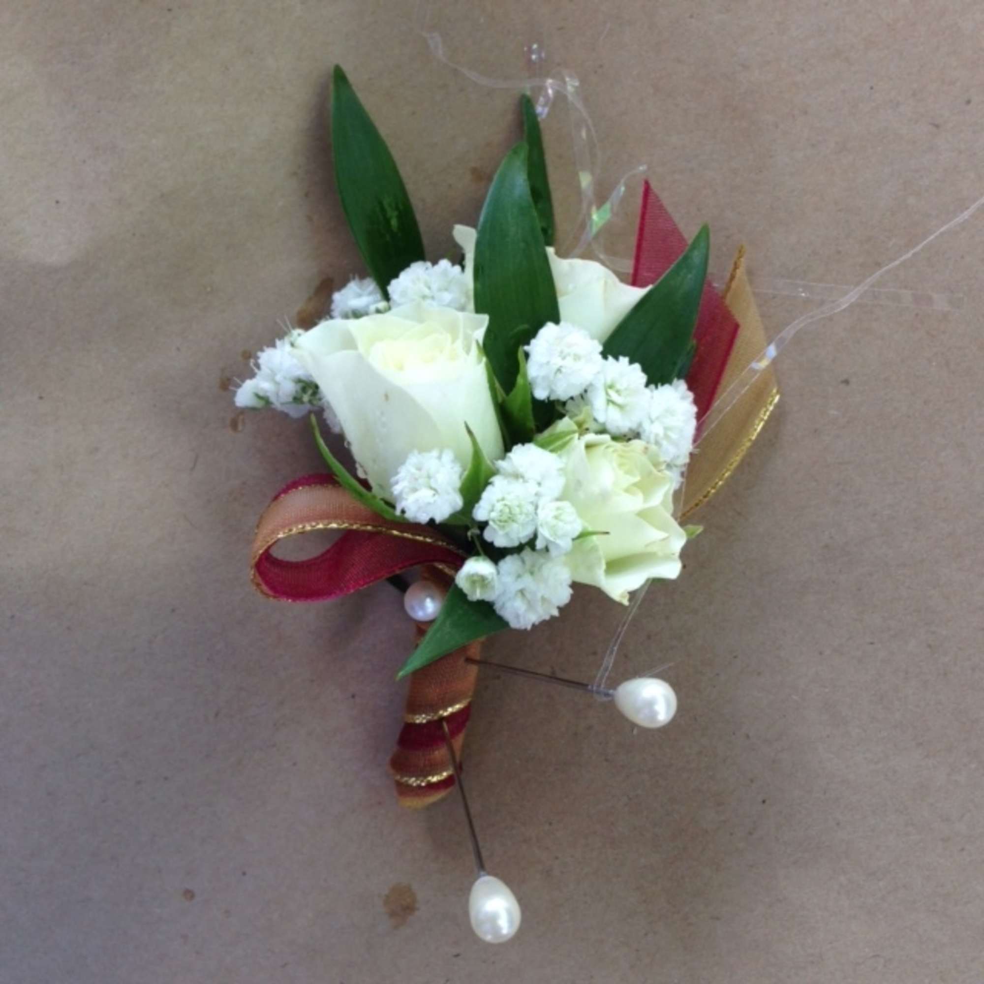 Small white rose boutonniere with ribbon and pearl pins