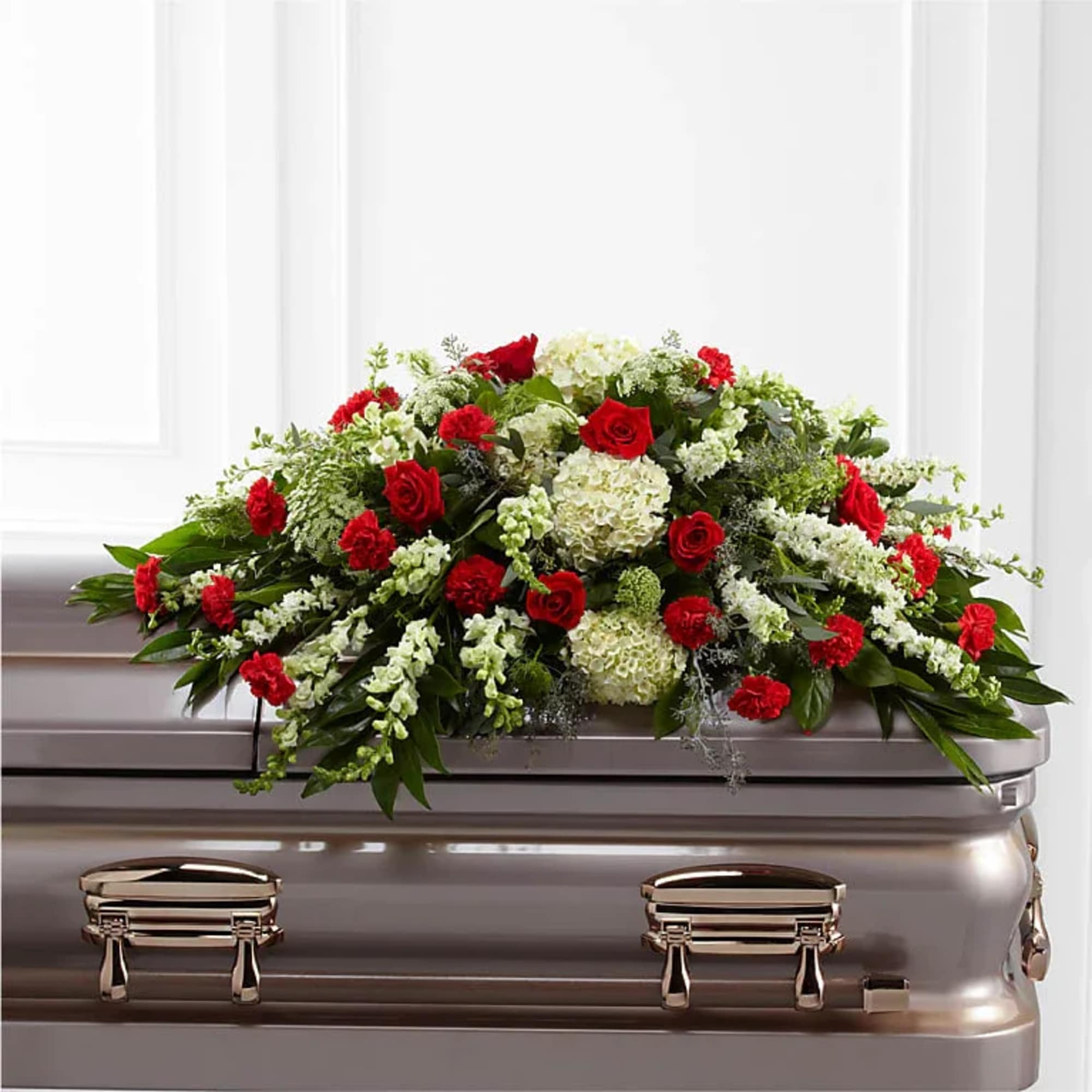 Red and white floral spray on a casket
