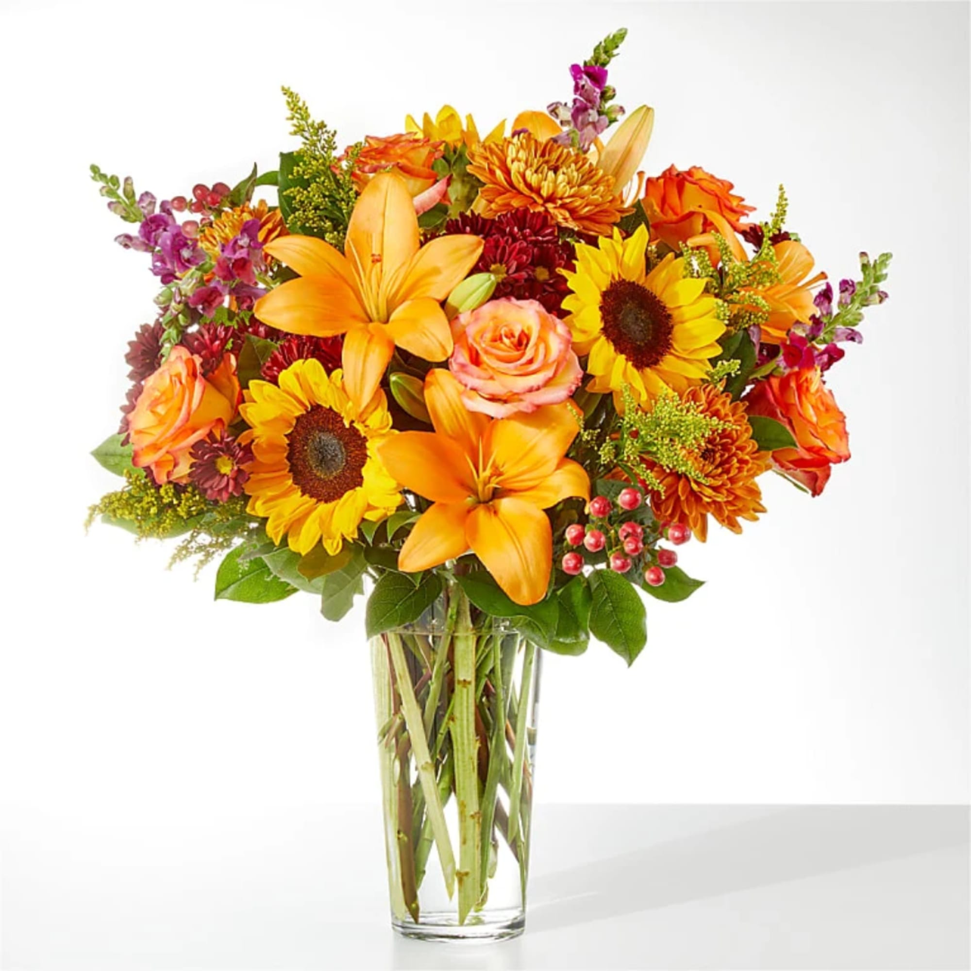 Orange and yellow mixed bouquet in a clear glass vase