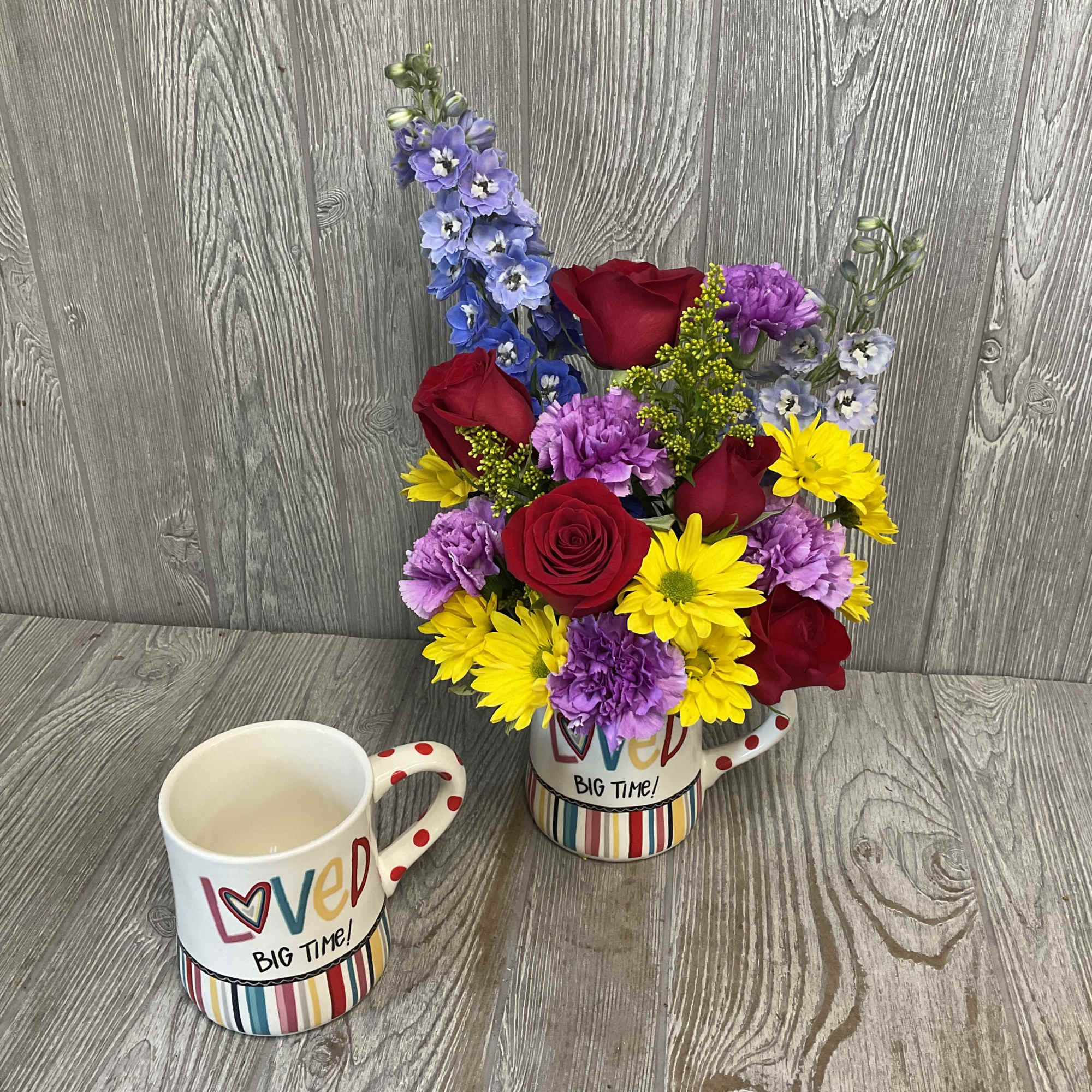Mixed bouquet in a novelty mug with a matching mug in front