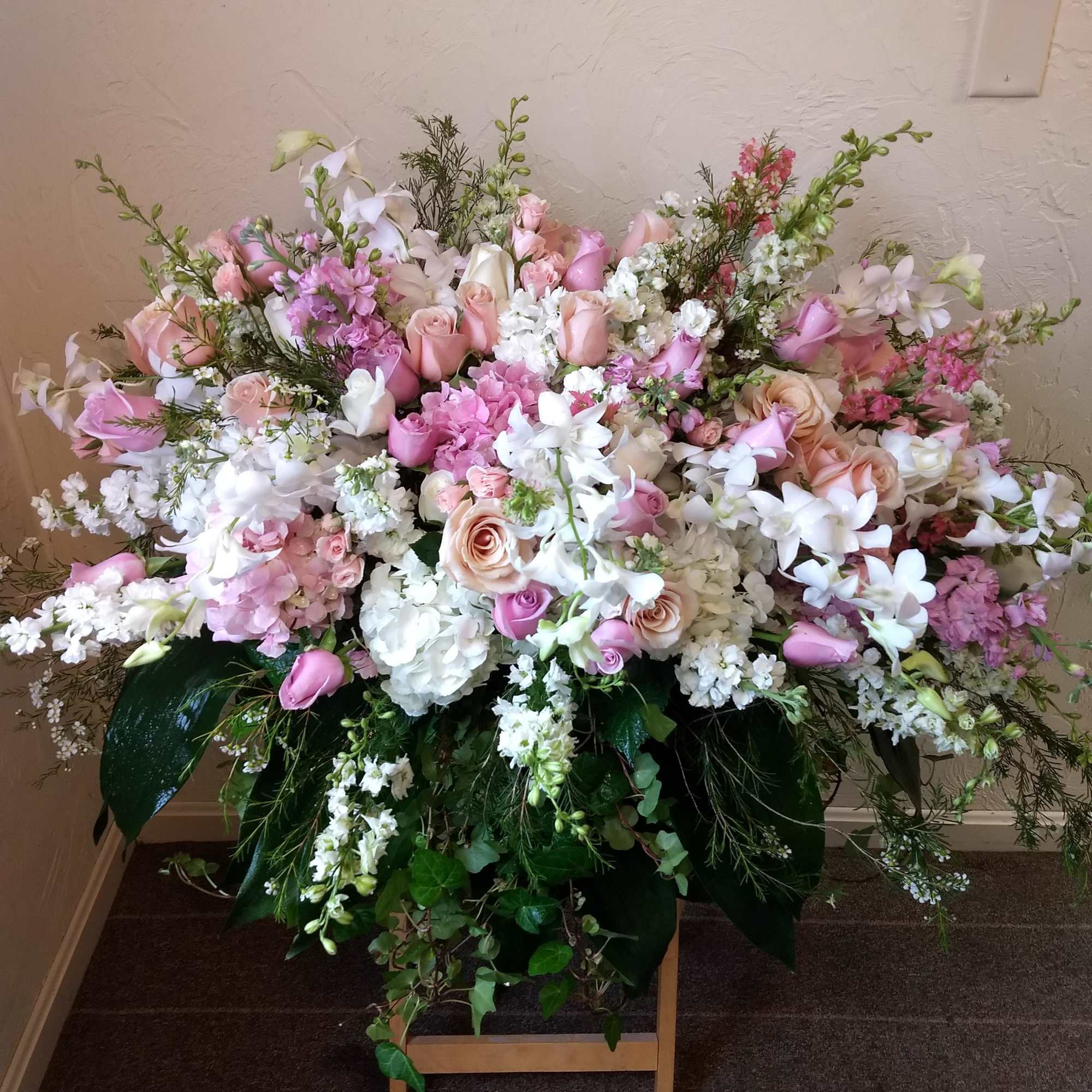 A beautiful spray of soft pink, white and cr&Atilde;&uml;me blooms ease the