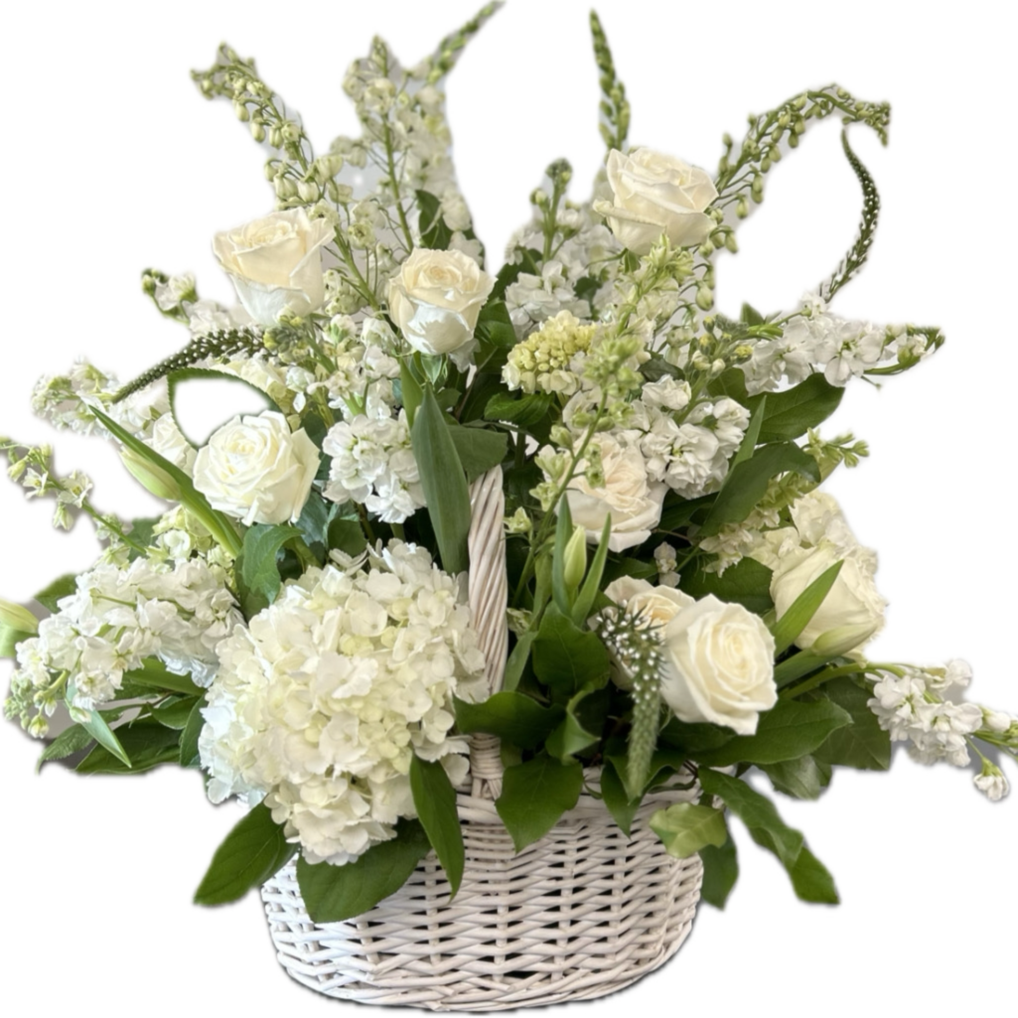 White roses and hydrangeas in a white wicker basket