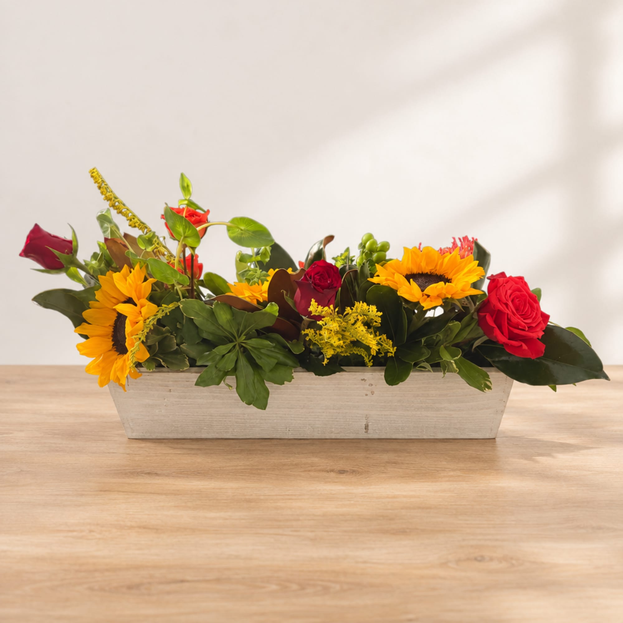 Rectangular flower arrangement with sunflowers and red roses in a white planter, photo 3 of 4