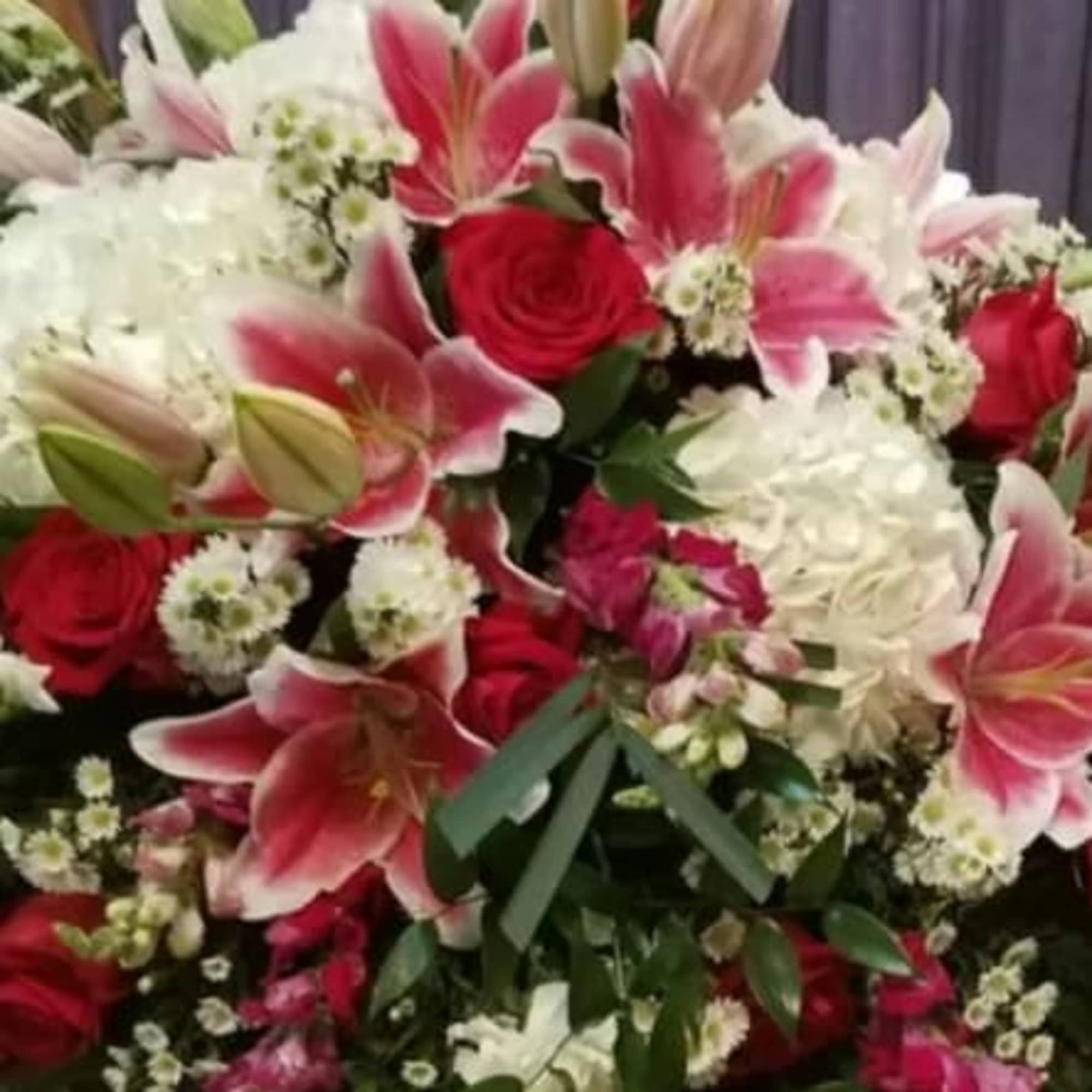 This large and graceful casket spray offers a beautiful tribute, filled with, photo 2 of 2