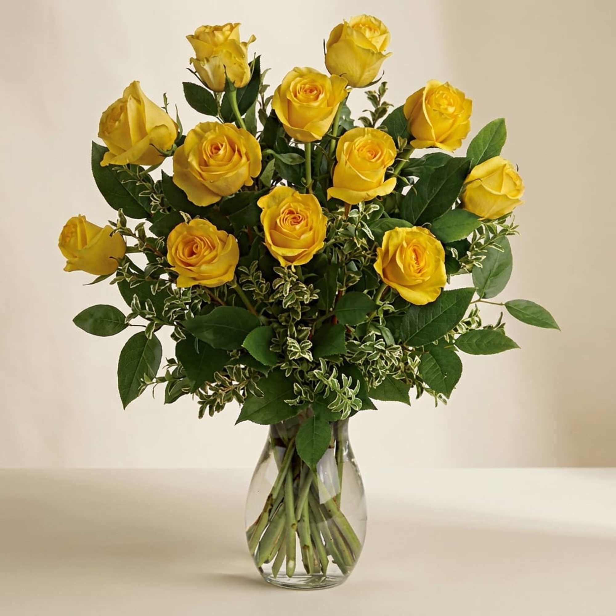 Yellow roses arranged in a clear glass vase