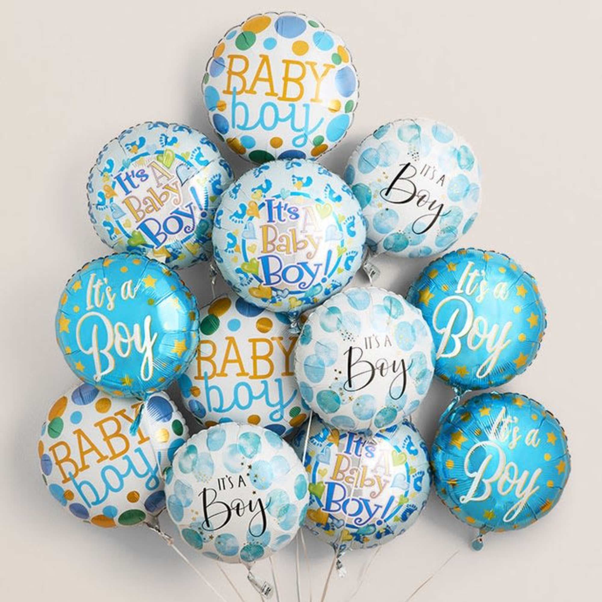 Cluster of blue and white baby boy balloons with printed messages