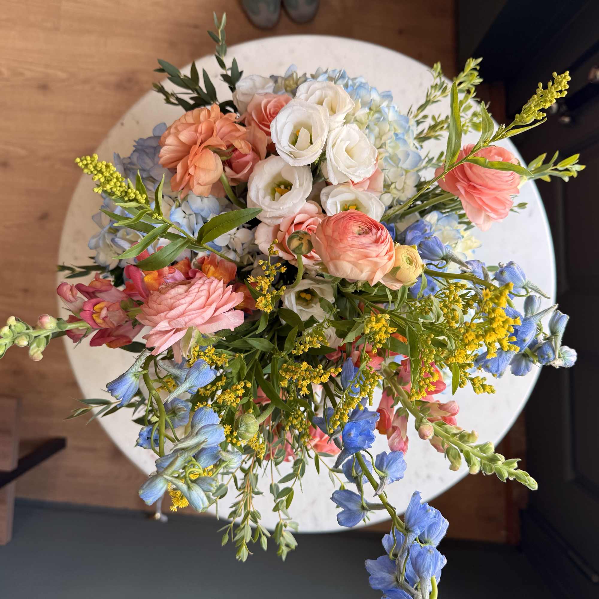 Mixed pastel bouquet with white, pink, blue, and yellow flowers