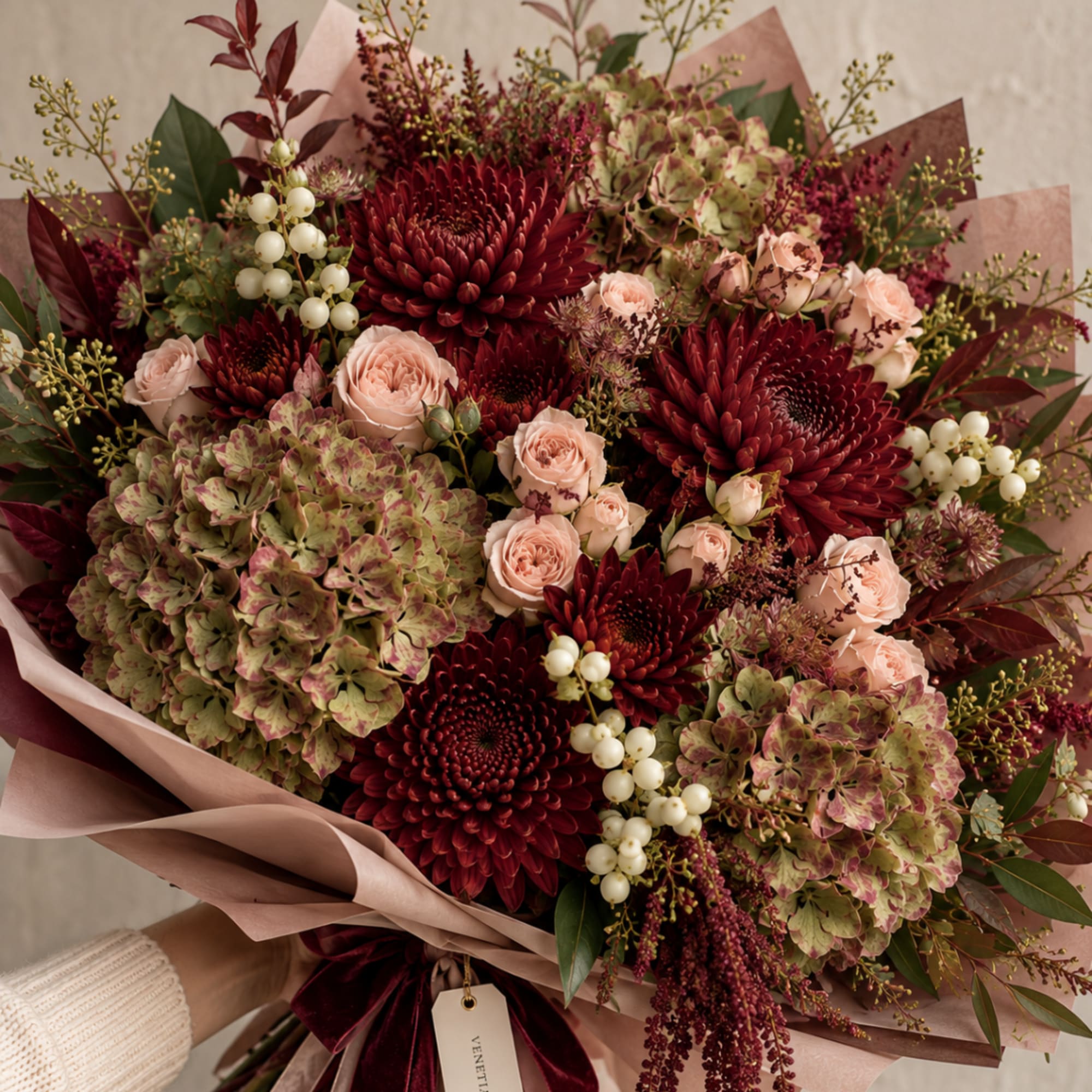 Bouquet of burgundy chrysanthemums, blush roses, and green hydrangeas