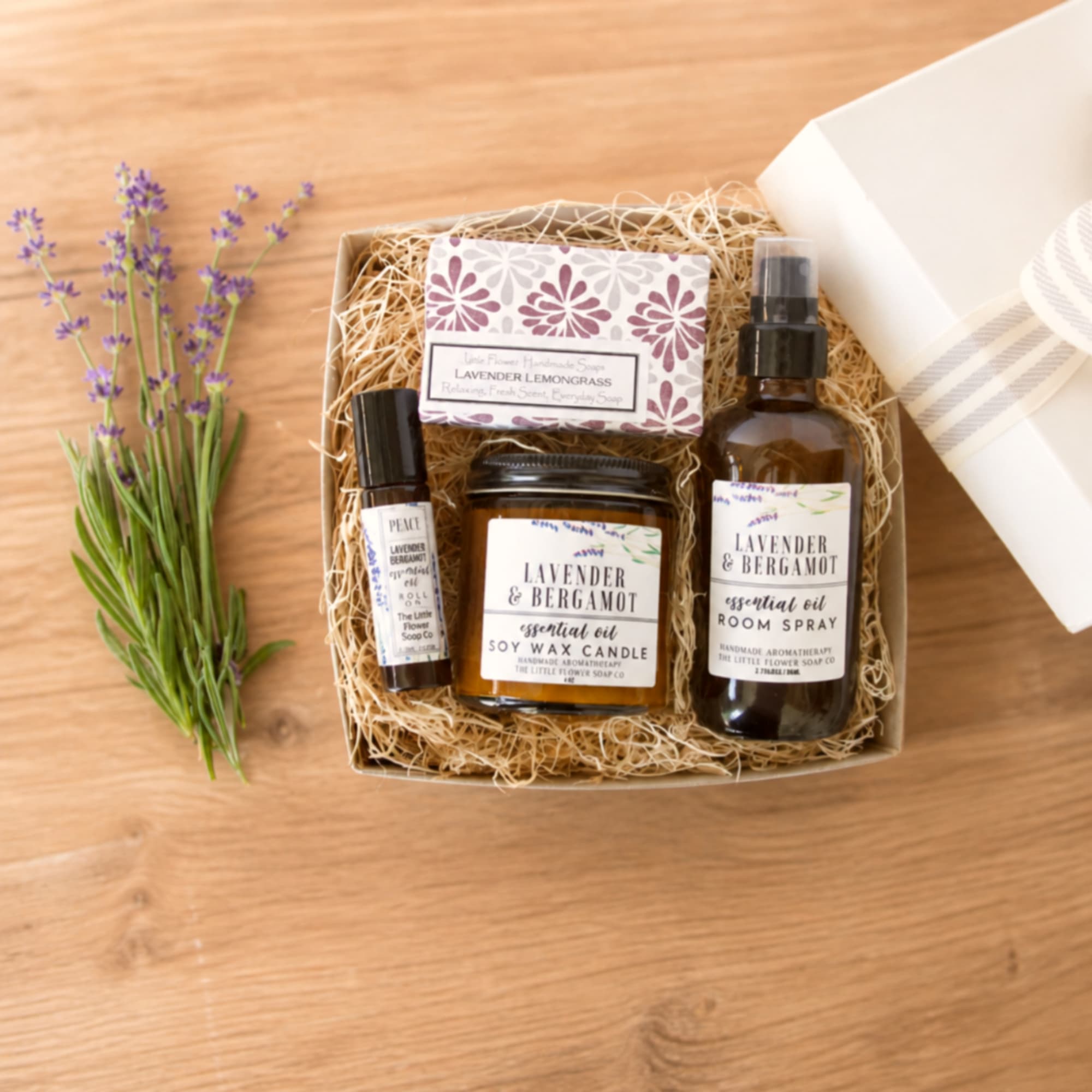 Lavender gift set with soap, candle, room spray, and a small sprig of purple flowers