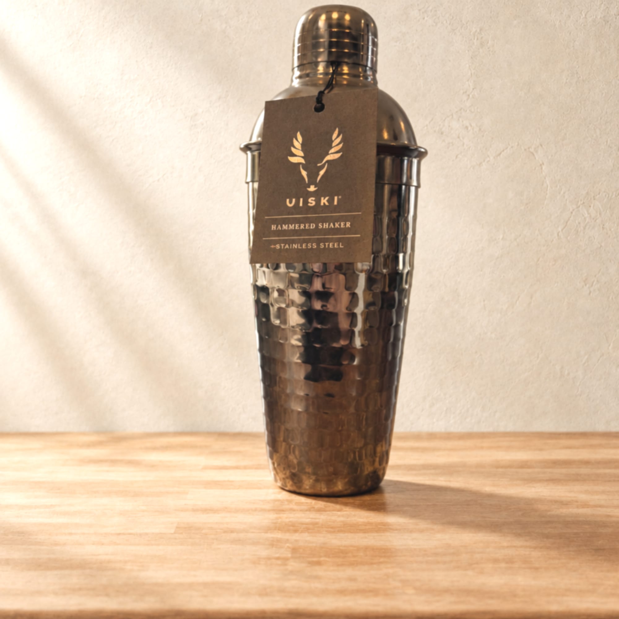 Hammered stainless steel cocktail shaker with a hanging tag