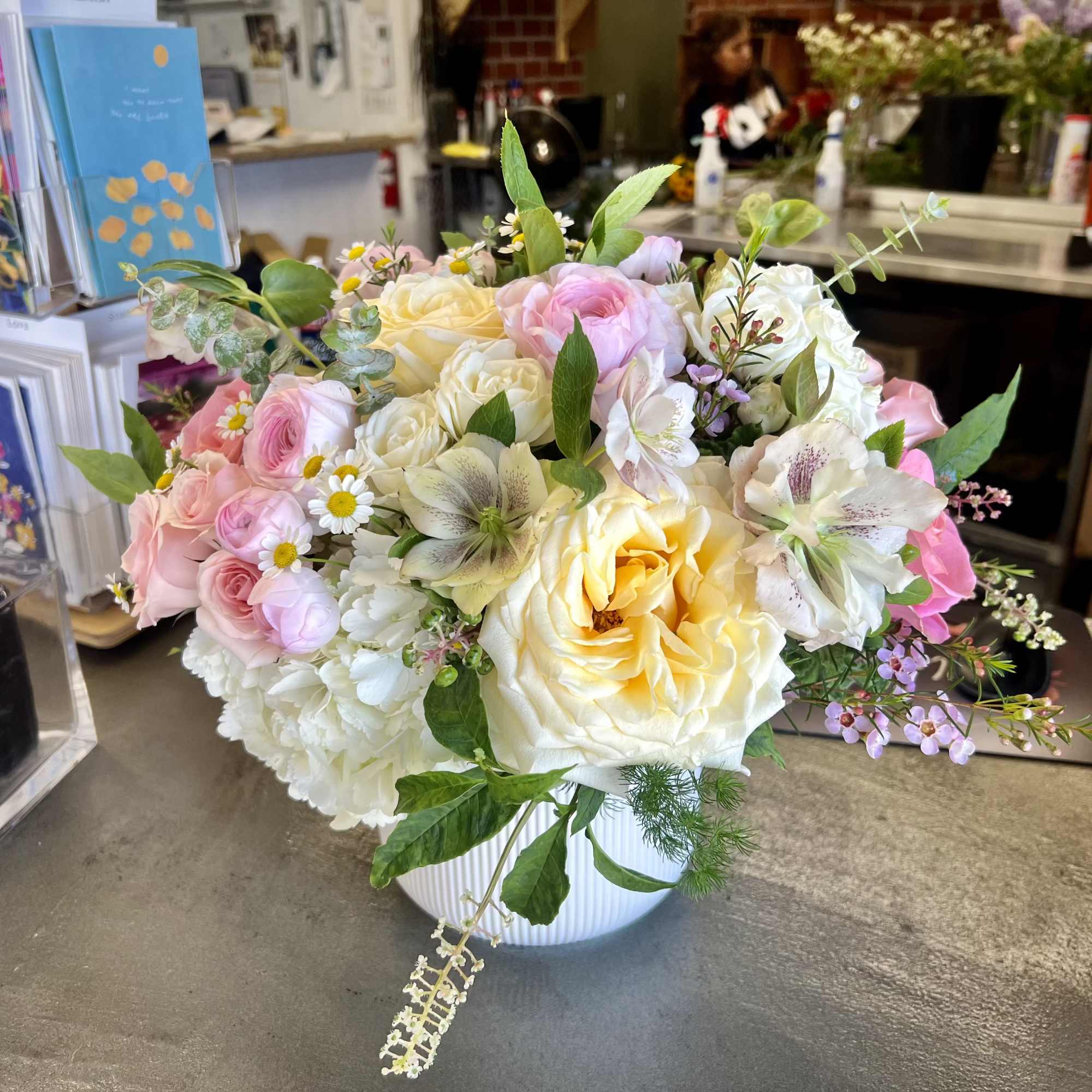 Bouquet of pink and cream roses in a white vase