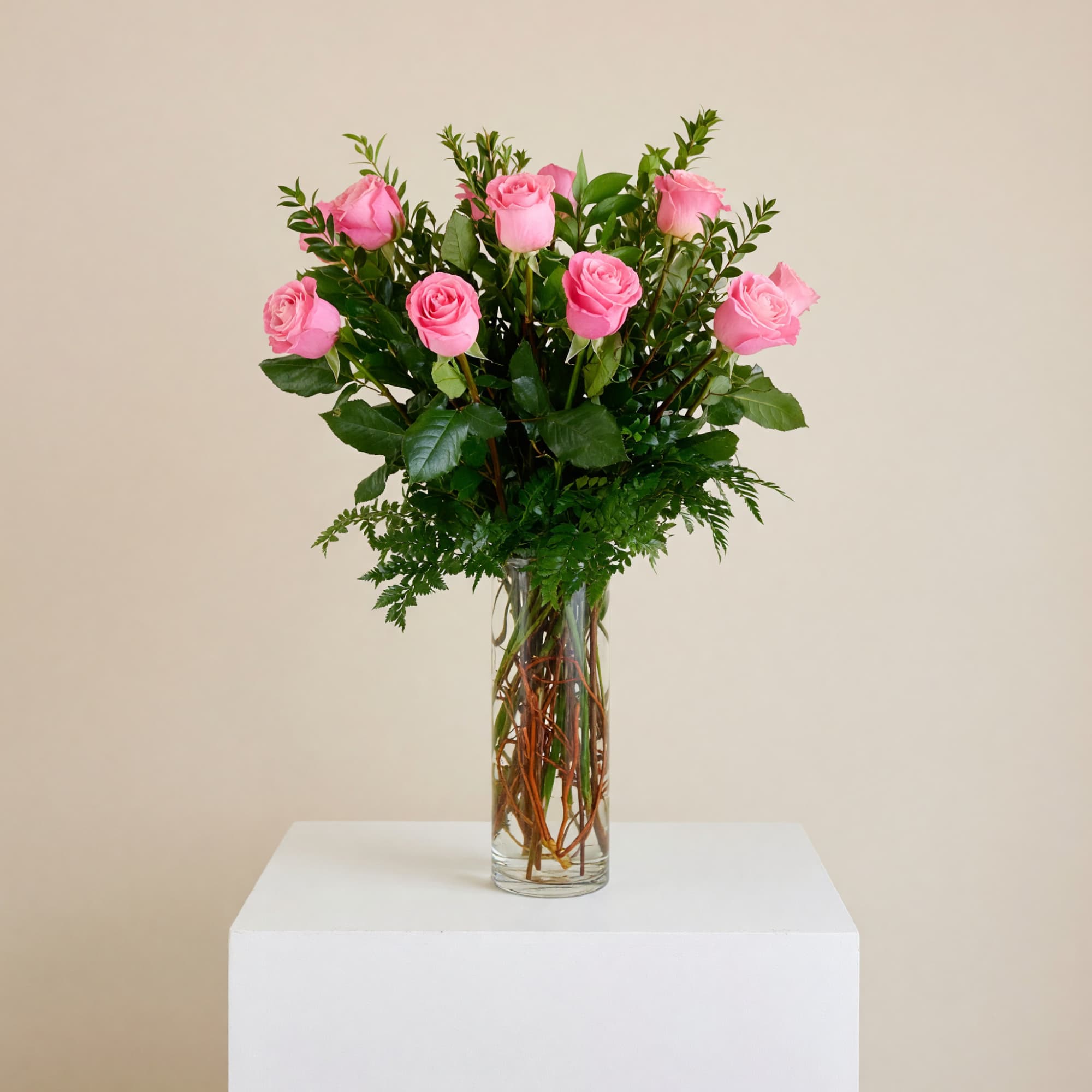 Pink roses arranged in a clear glass vase