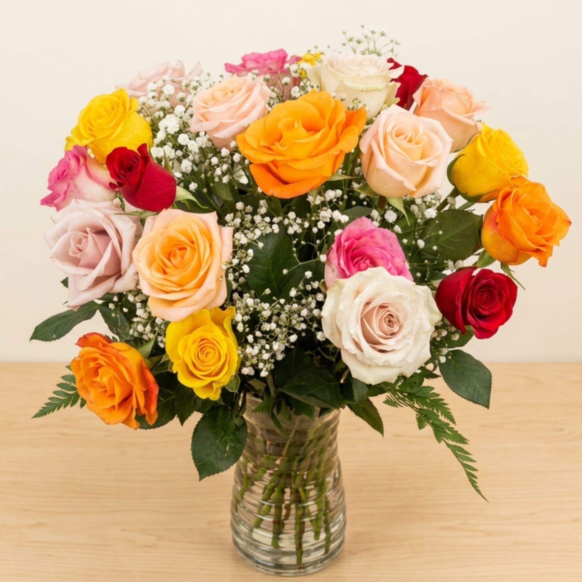 Mixed roses in a clear glass vase with baby's breath, photo 2 of 2