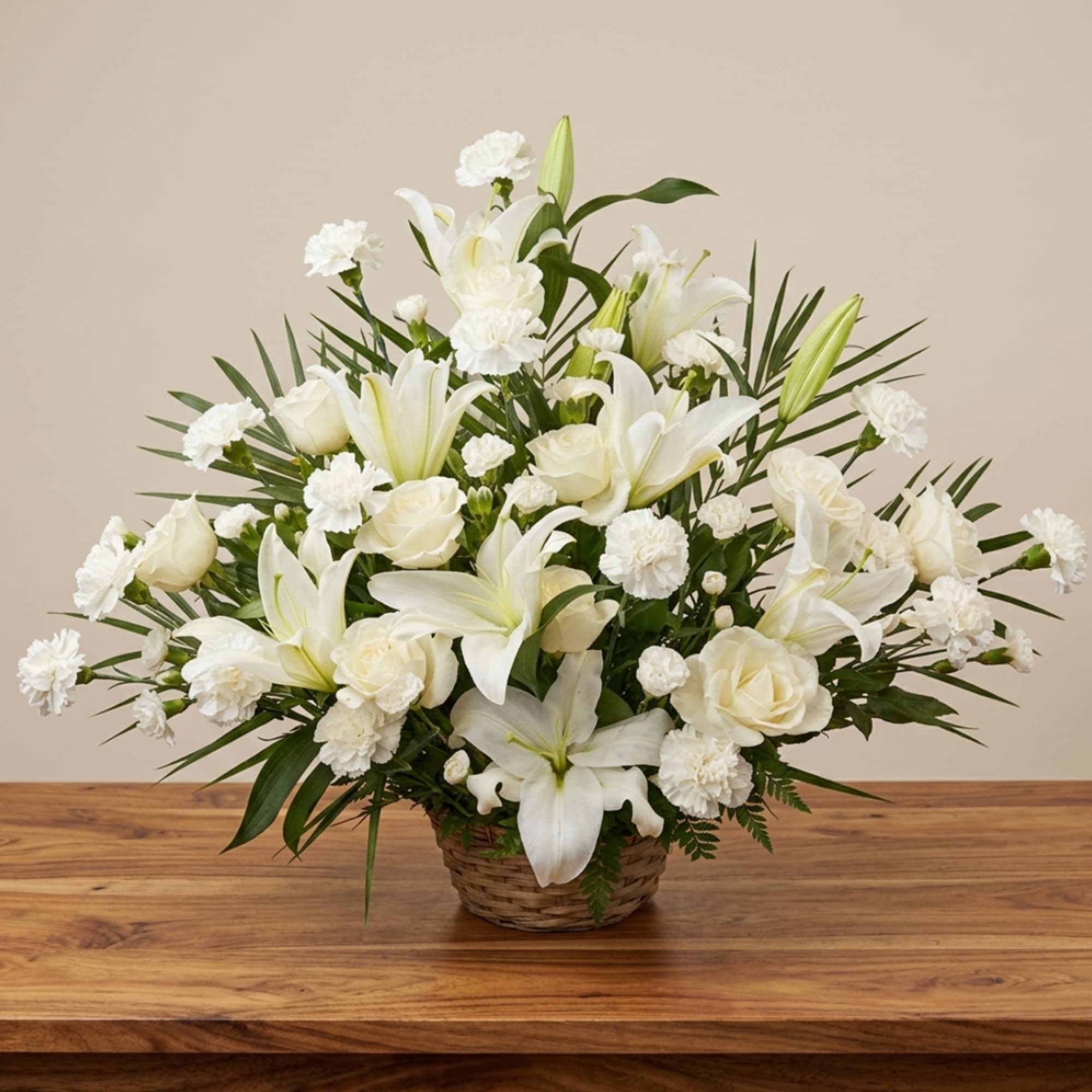 White lilies and roses arranged in a wicker basket