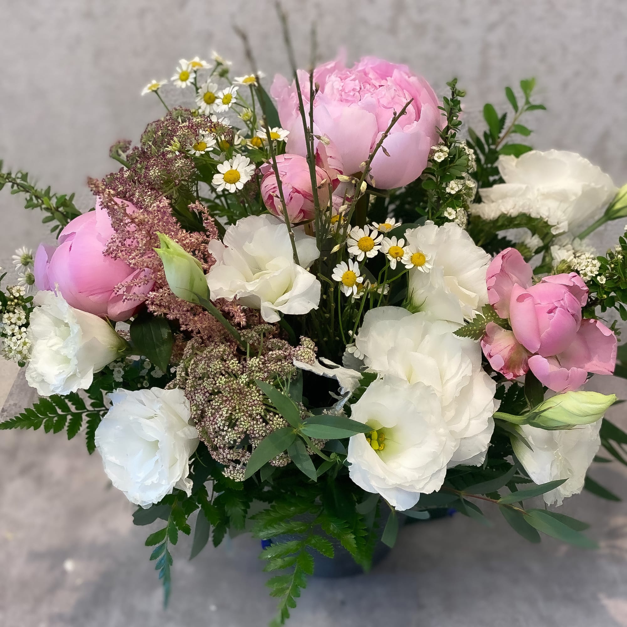 Pink and white bouquet with peonies and small daisy flowers