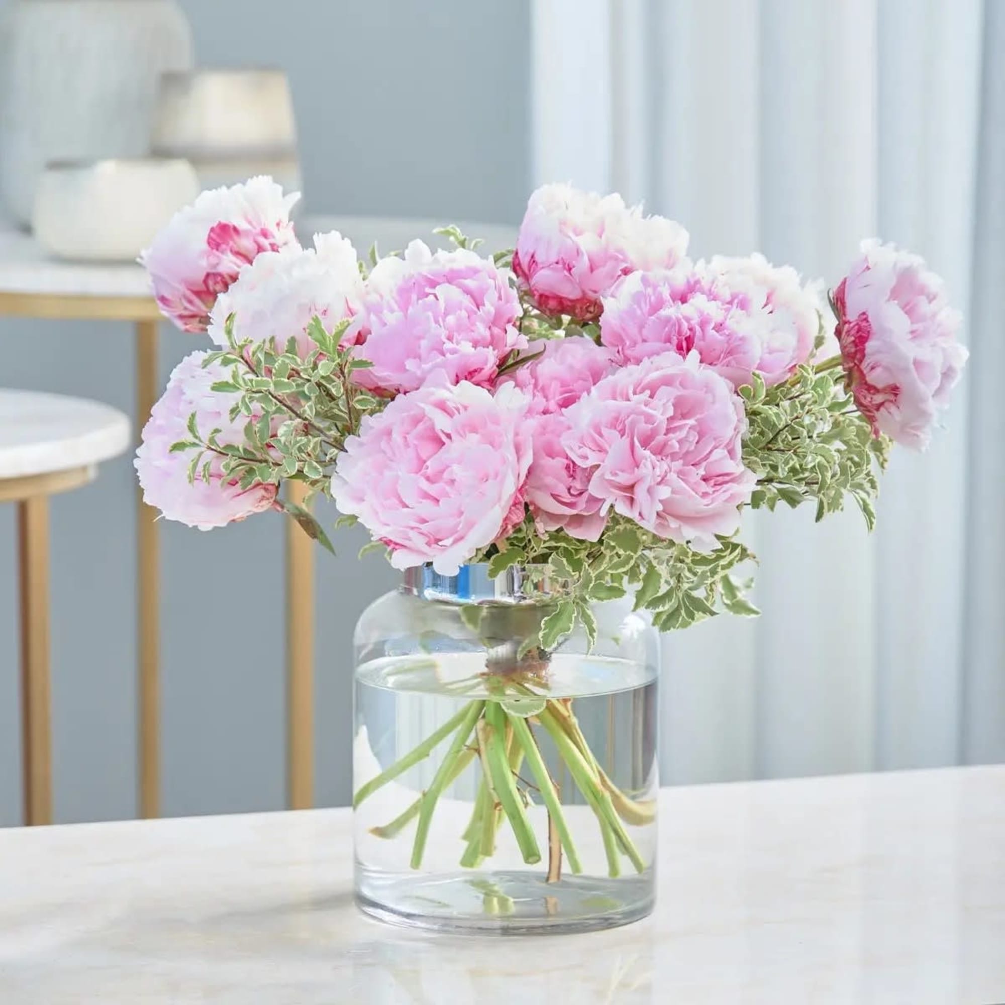 Pink peonies in a clear glass vase