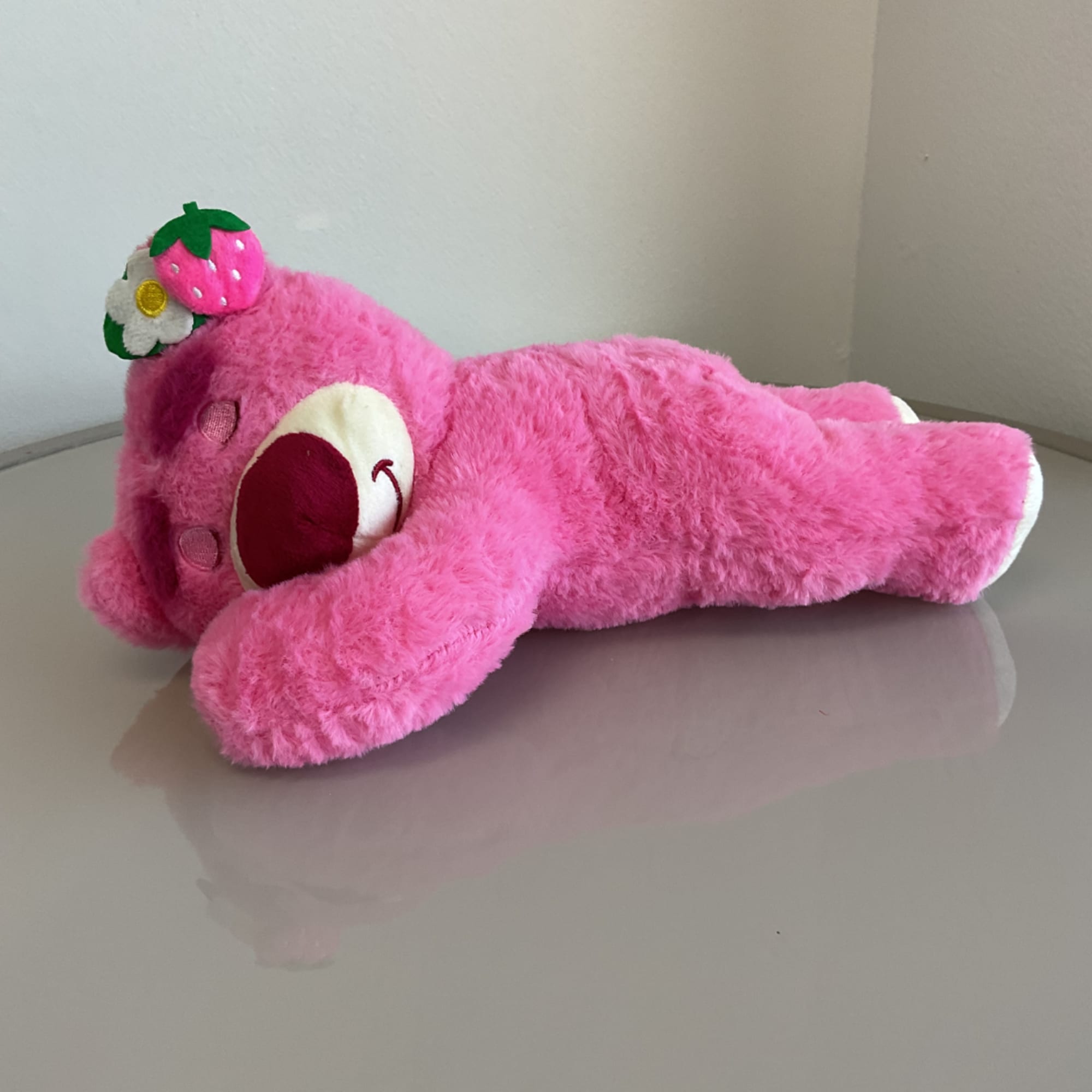Pink teddy bear plush with a strawberry on its head