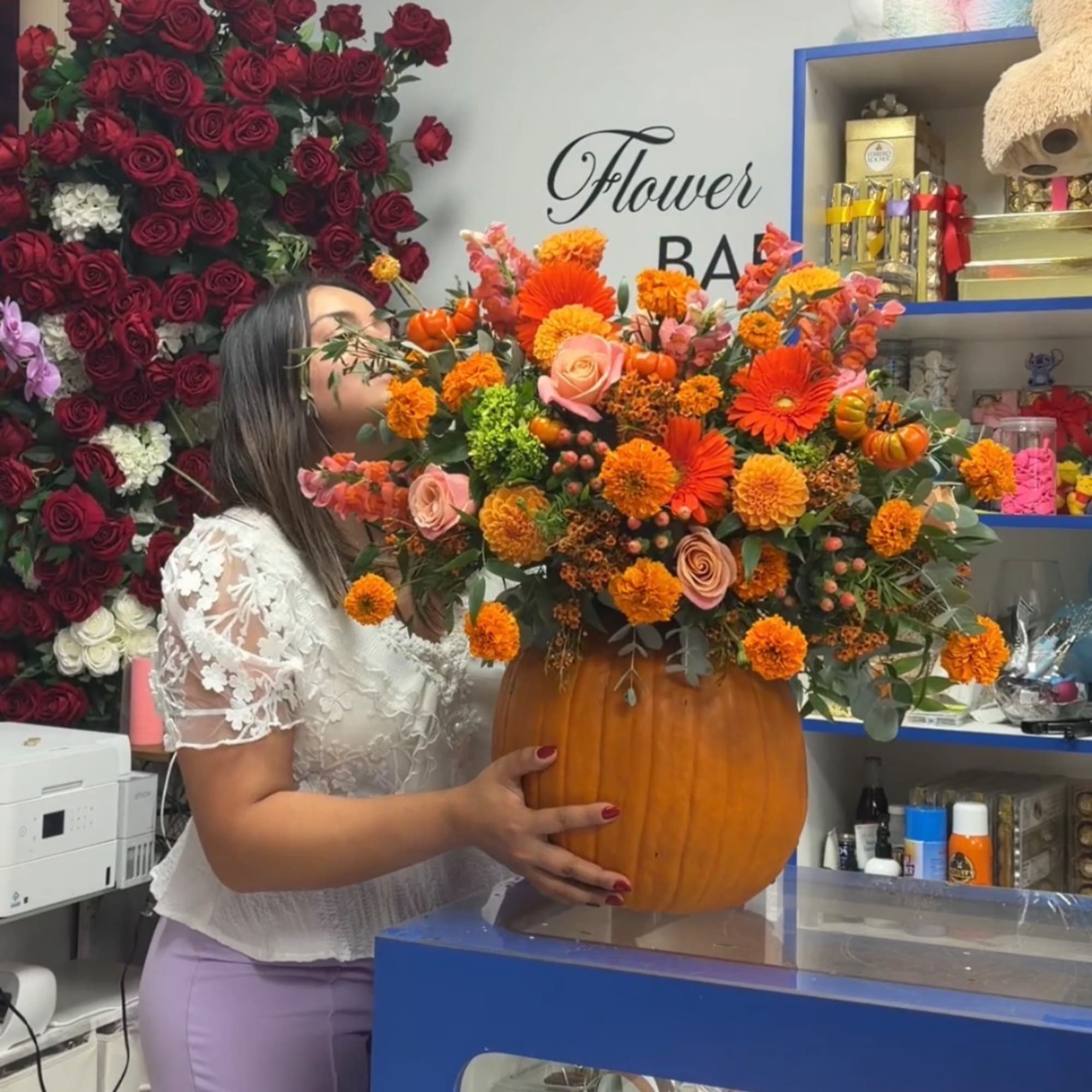 Orange floral arrangement in a pumpkin container with roses and mums, photo 4 of 4
