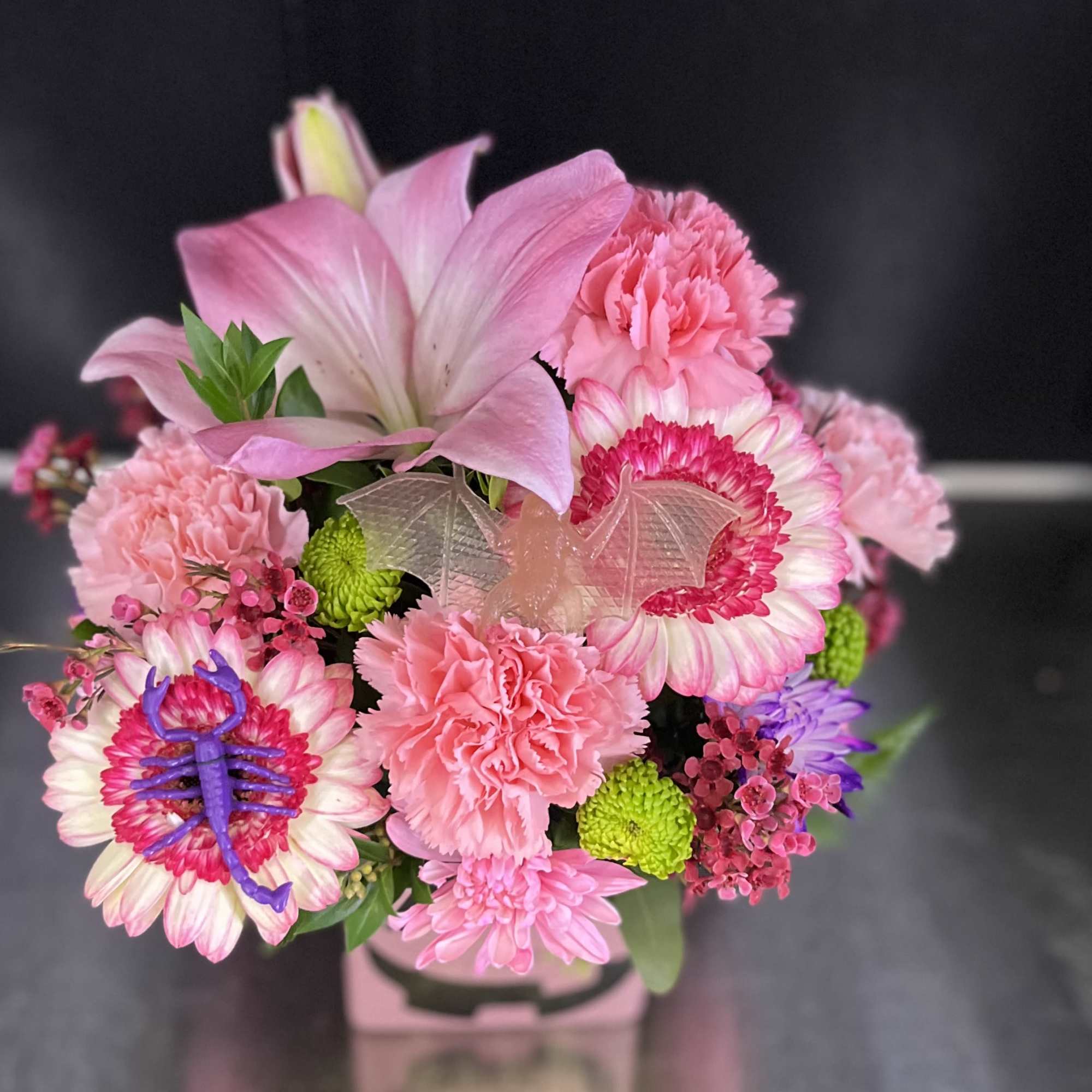 Pink bouquet with lilies, carnations, and daisies in a vase