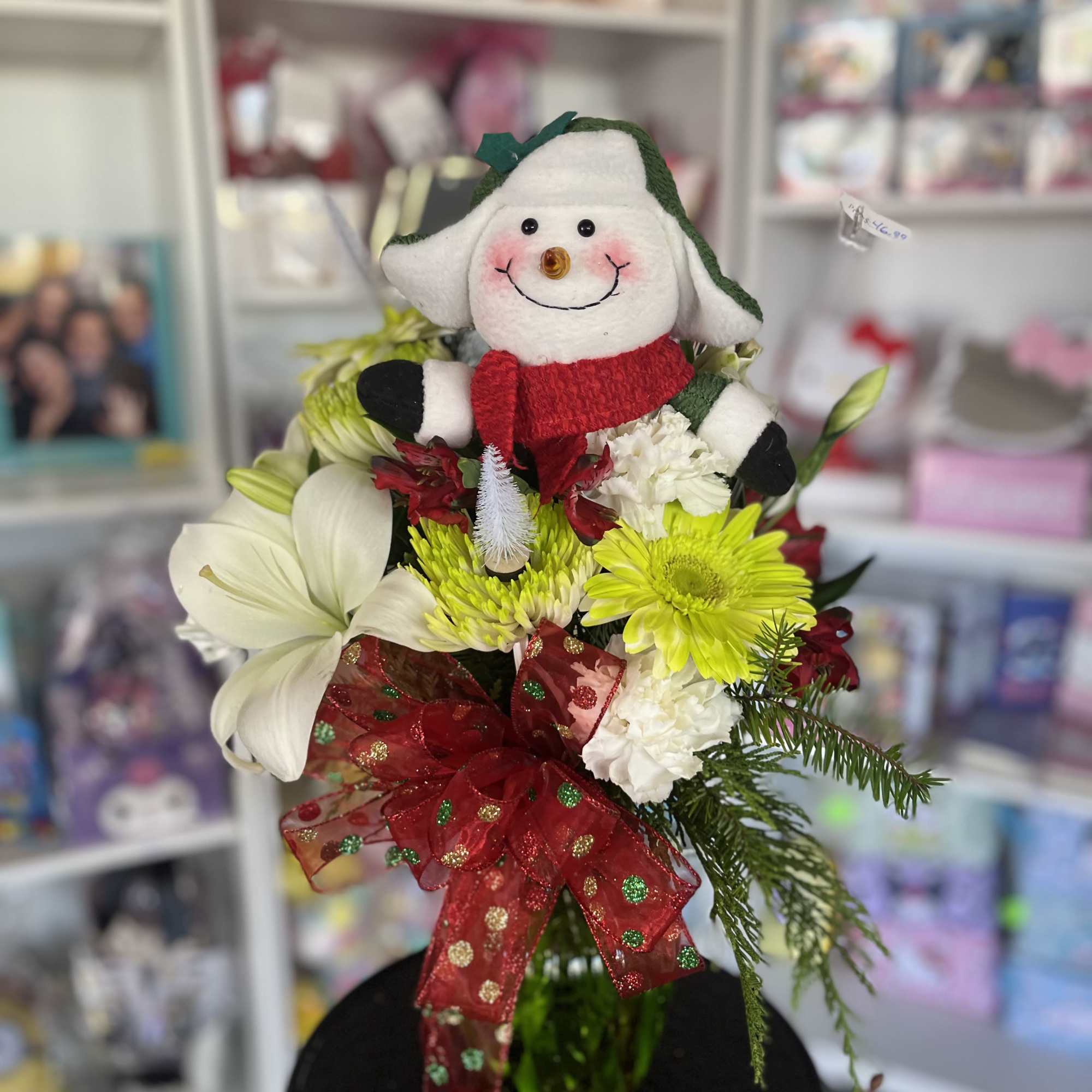 Holiday bouquet with a plush snowman and red ribbon