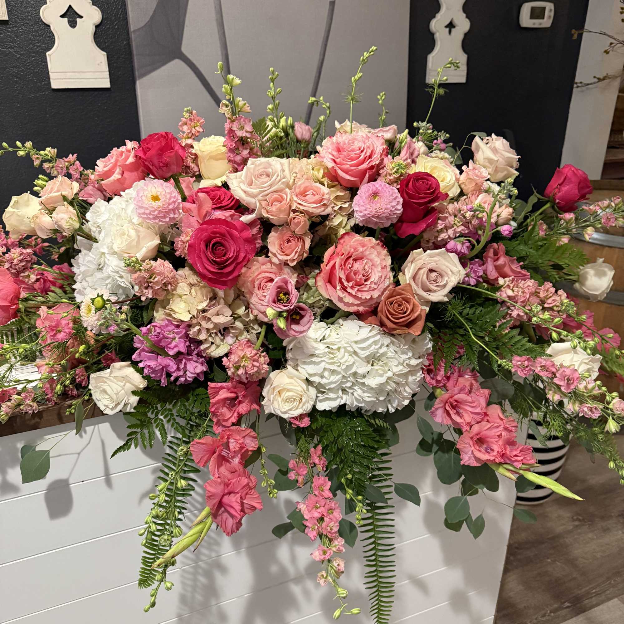 Large pink and white floral arrangement with roses and hydrangeas